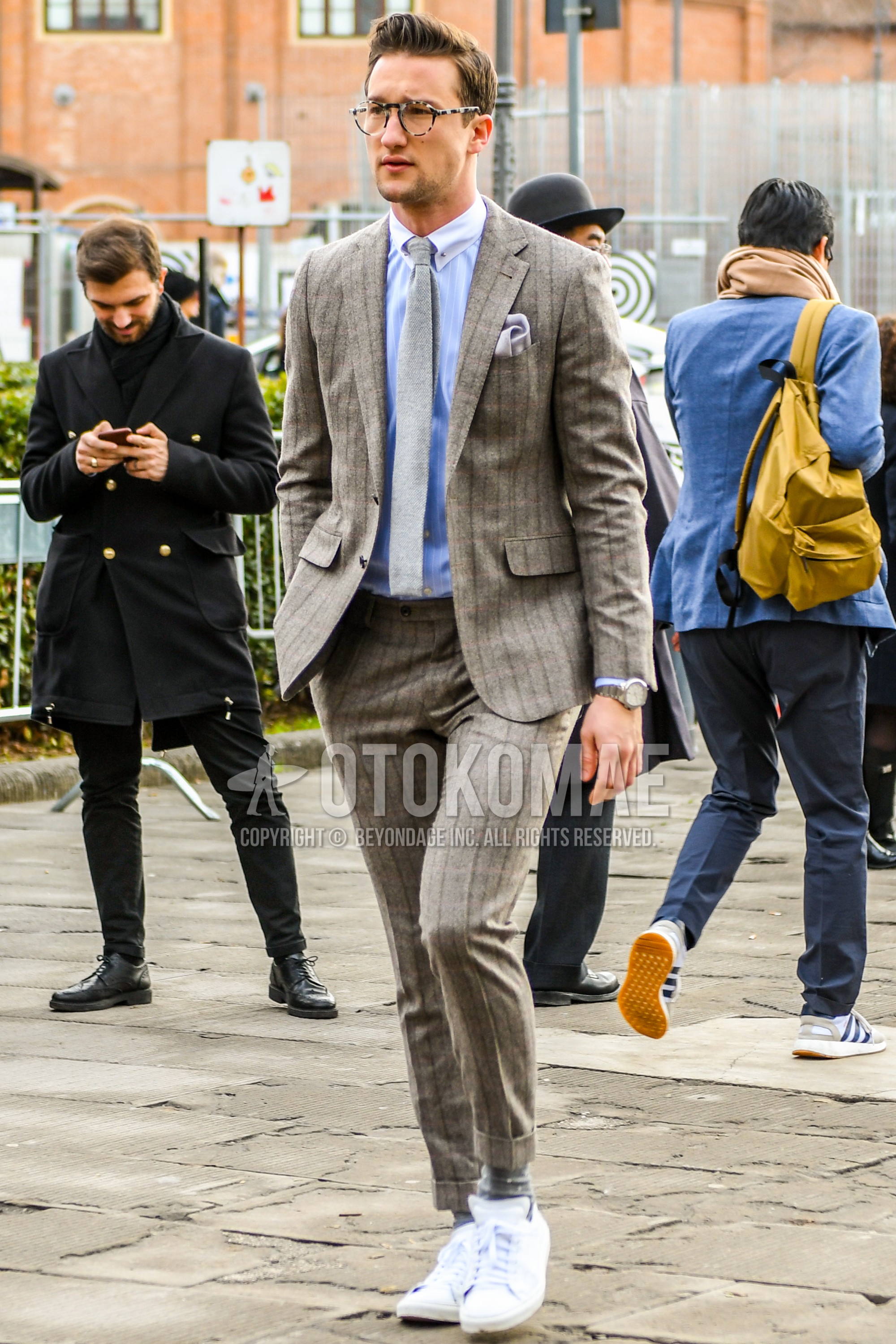Men's spring autumn outfit with plain glasses, white plain shirt, gray plain socks, beige stripes suit, gray plain necktie.