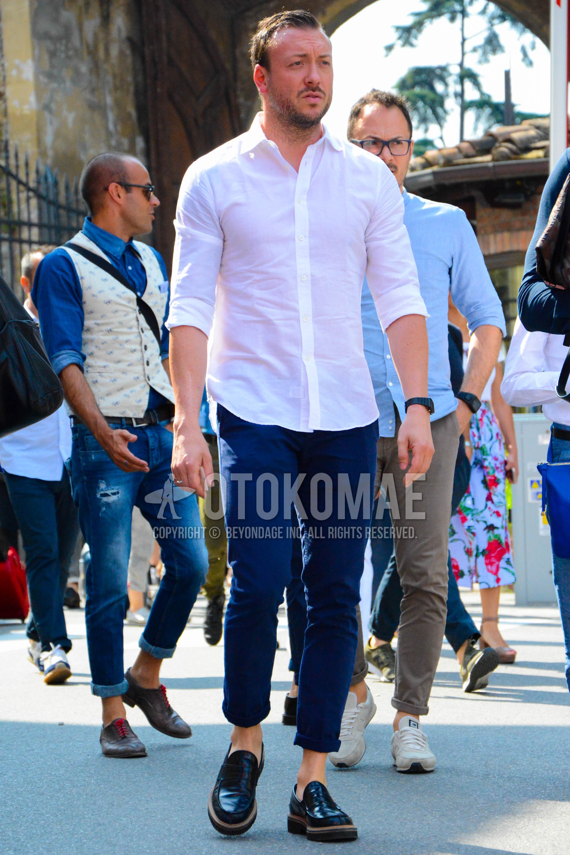 Men's spring summer autumn outfit with white plain shirt, navy plain cotton pants, black coin loafers leather shoes.