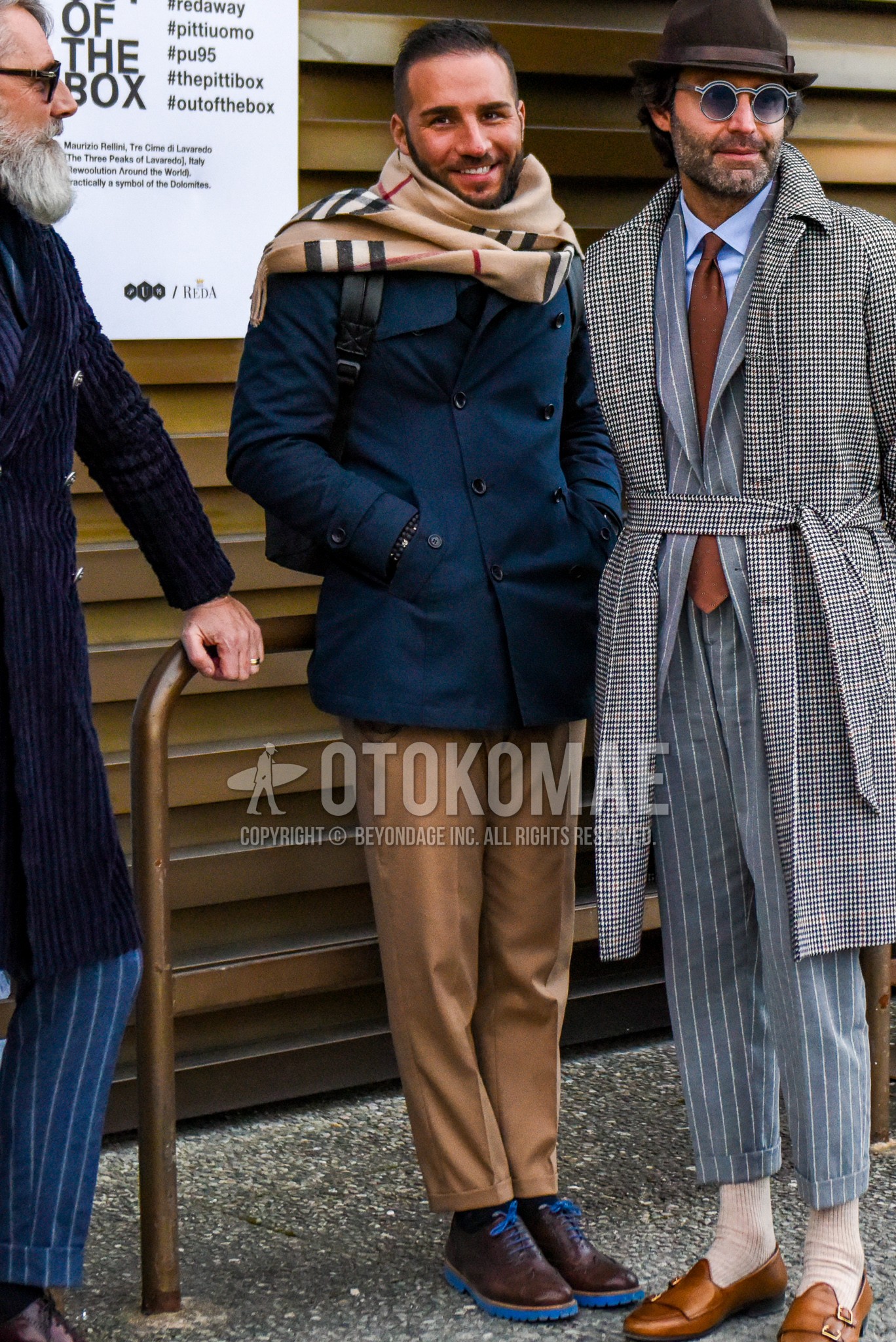 Men's autumn winter outfit with beige check scarf, navy plain p coat, brown plain chinos, brown plain toe leather shoes.