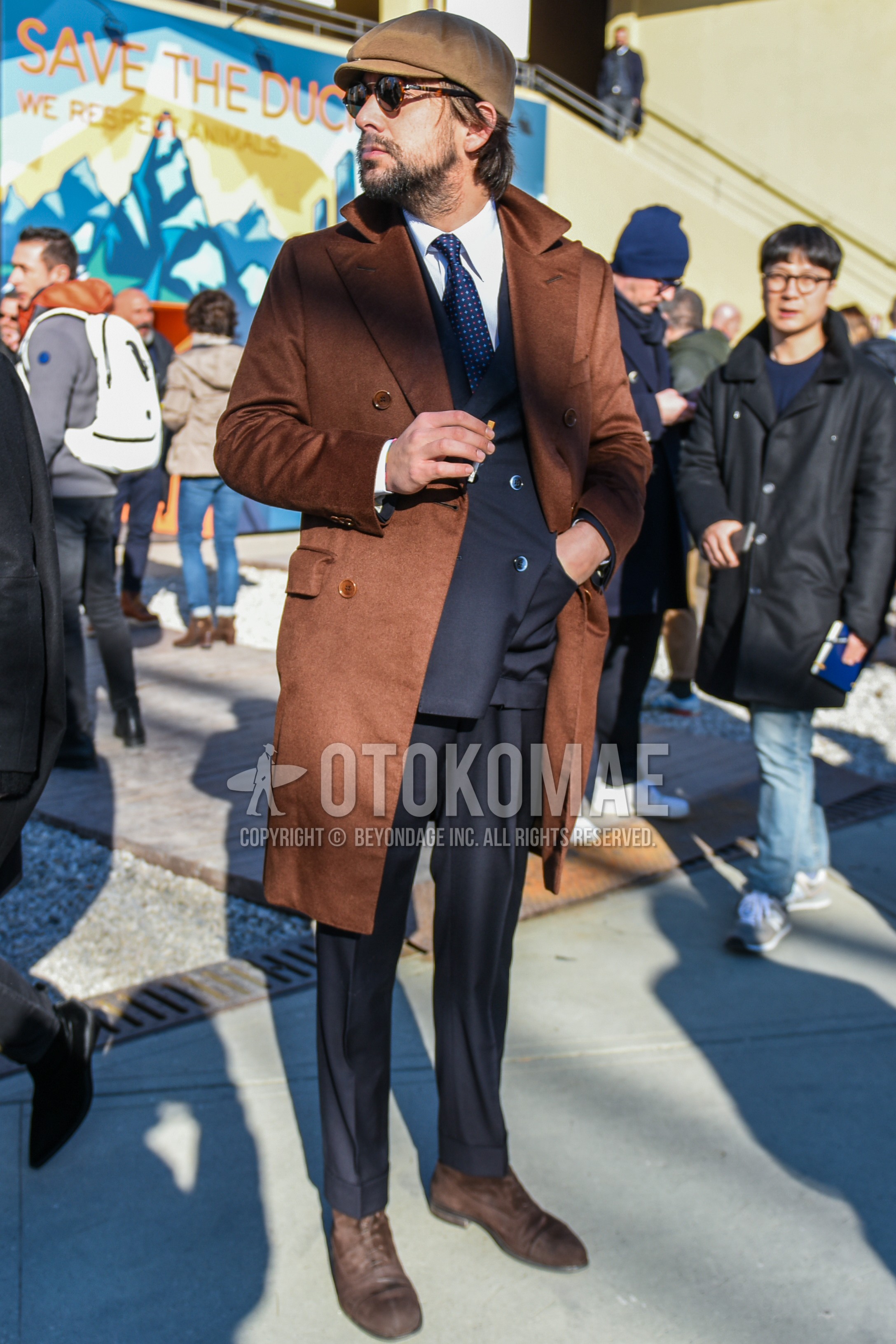 Men's autumn winter outfit with beige plain hunting cap, brown tortoiseshell sunglasses, brown plain chester coat, white plain shirt, brown  boots, dark gray plain suit, navy necktie necktie.