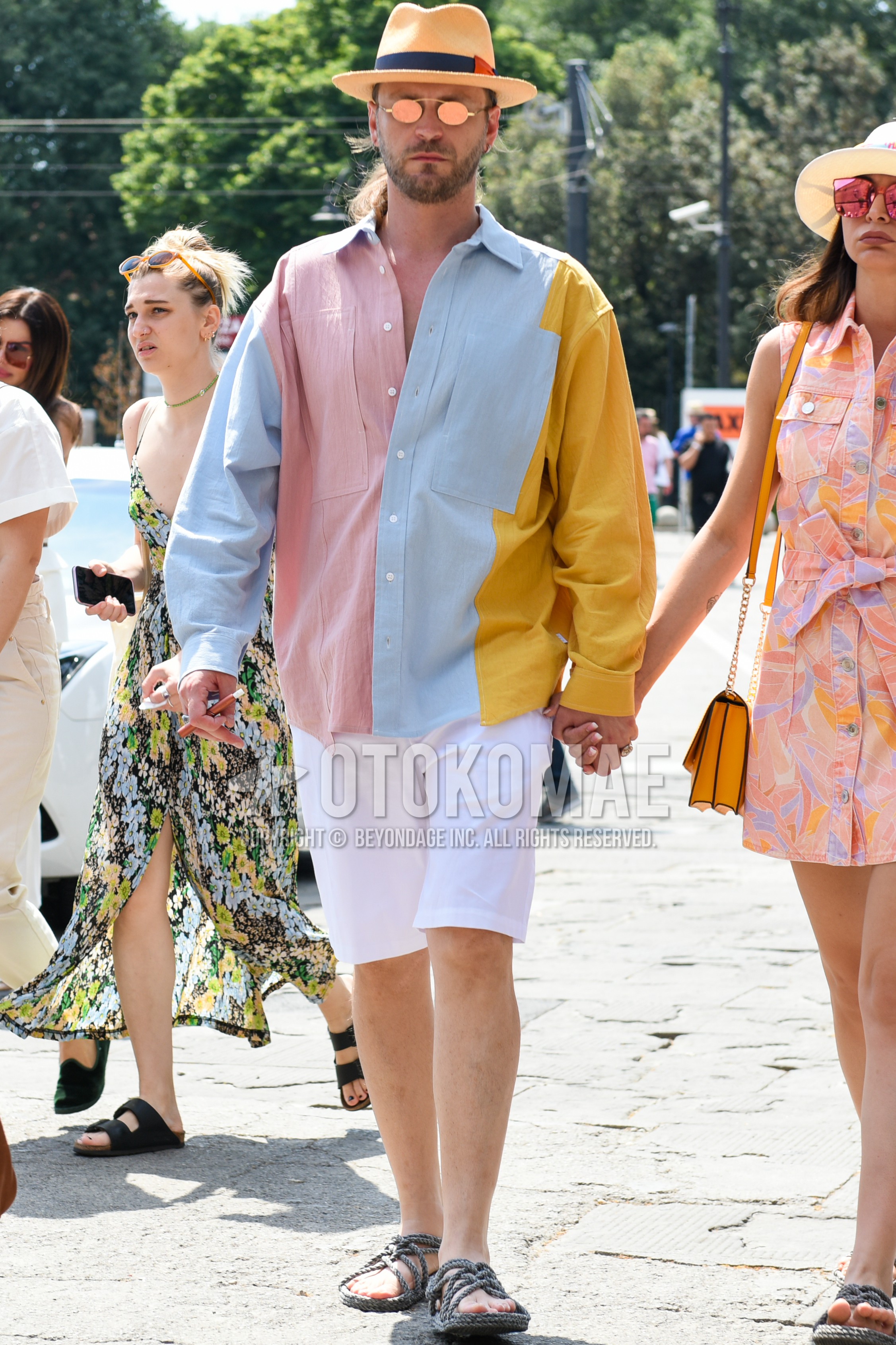 Men's summer outfit with beige plain hat, gold plain sunglasses, multi-color plain shirt, white plain short pants, gray flip flops sandals.