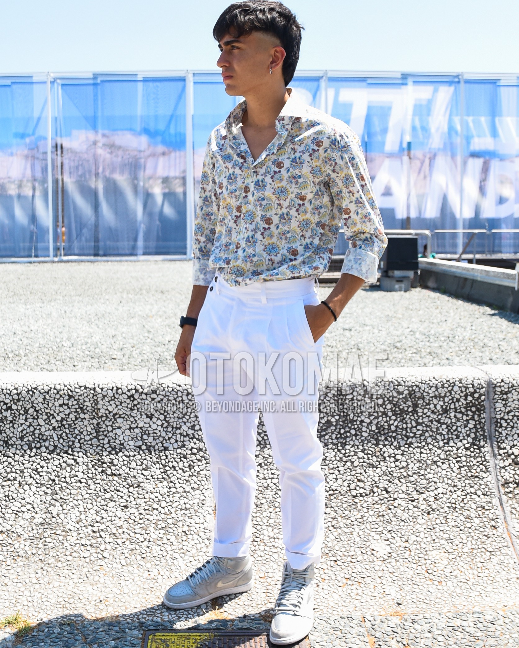 Men's spring summer outfit with white tops/innerwear shirt, white plain slacks, silver high-cut sneakers.