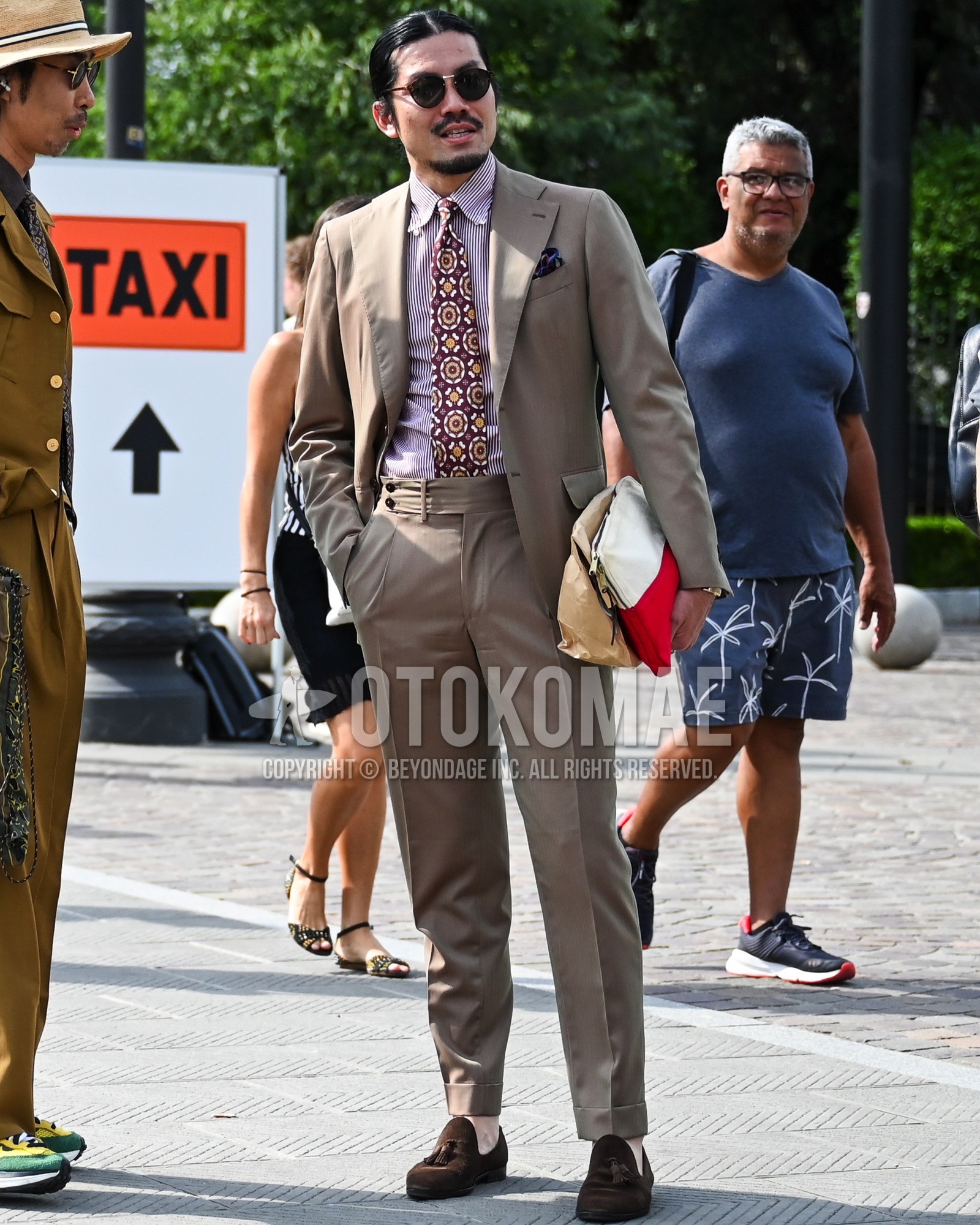 Men's spring summer autumn outfit with black plain sunglasses, pink plain shirt, brown tassel loafers leather shoes, brown suede shoes leather shoes, brown plain suit, red whole pattern necktie.