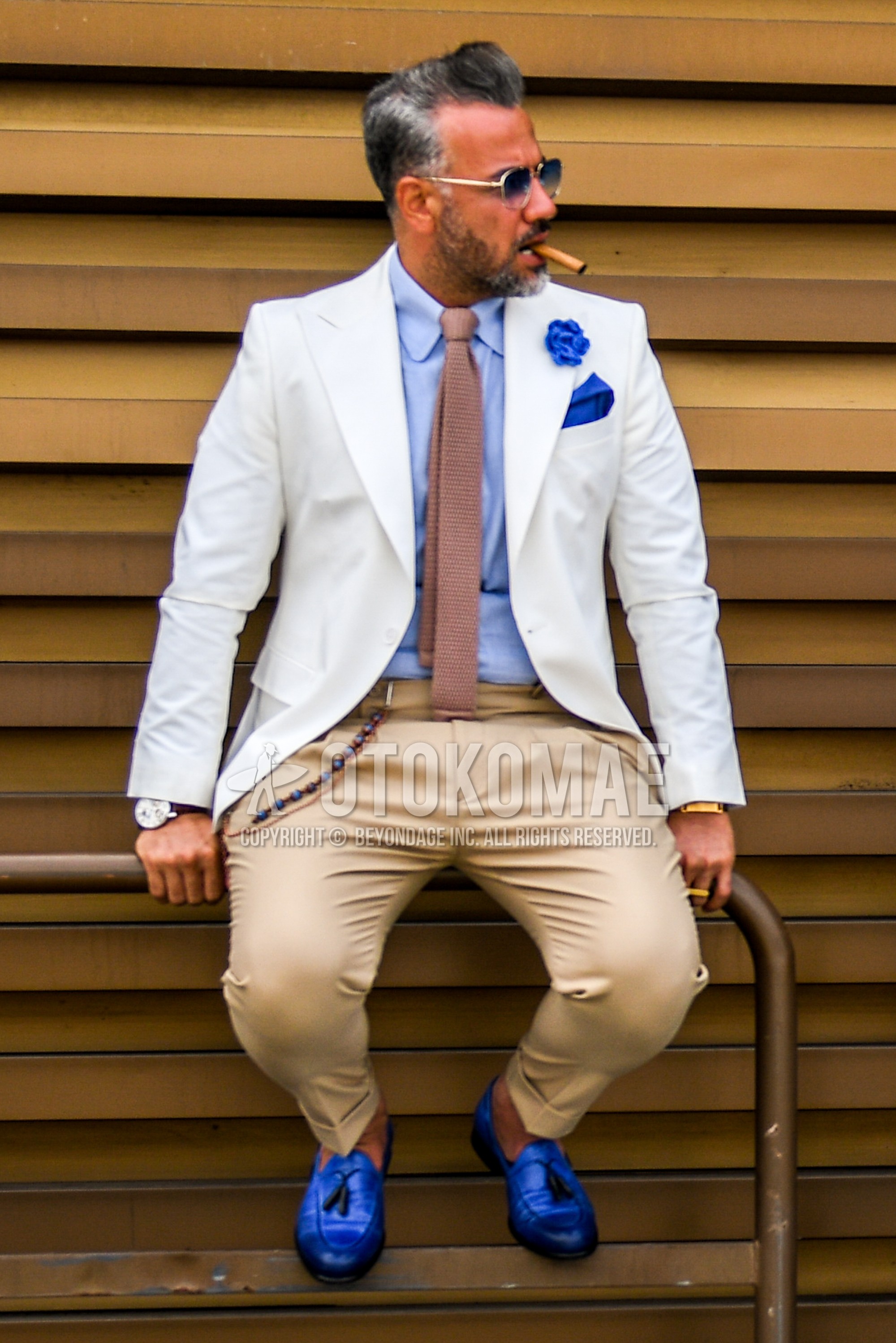 Men's spring summer autumn outfit with plain sunglasses, white plain tailored jacket, blue plain shirt, beige plain slacks, plain pleated pants, blue tassel loafers leather shoes, beige plain knit tie.