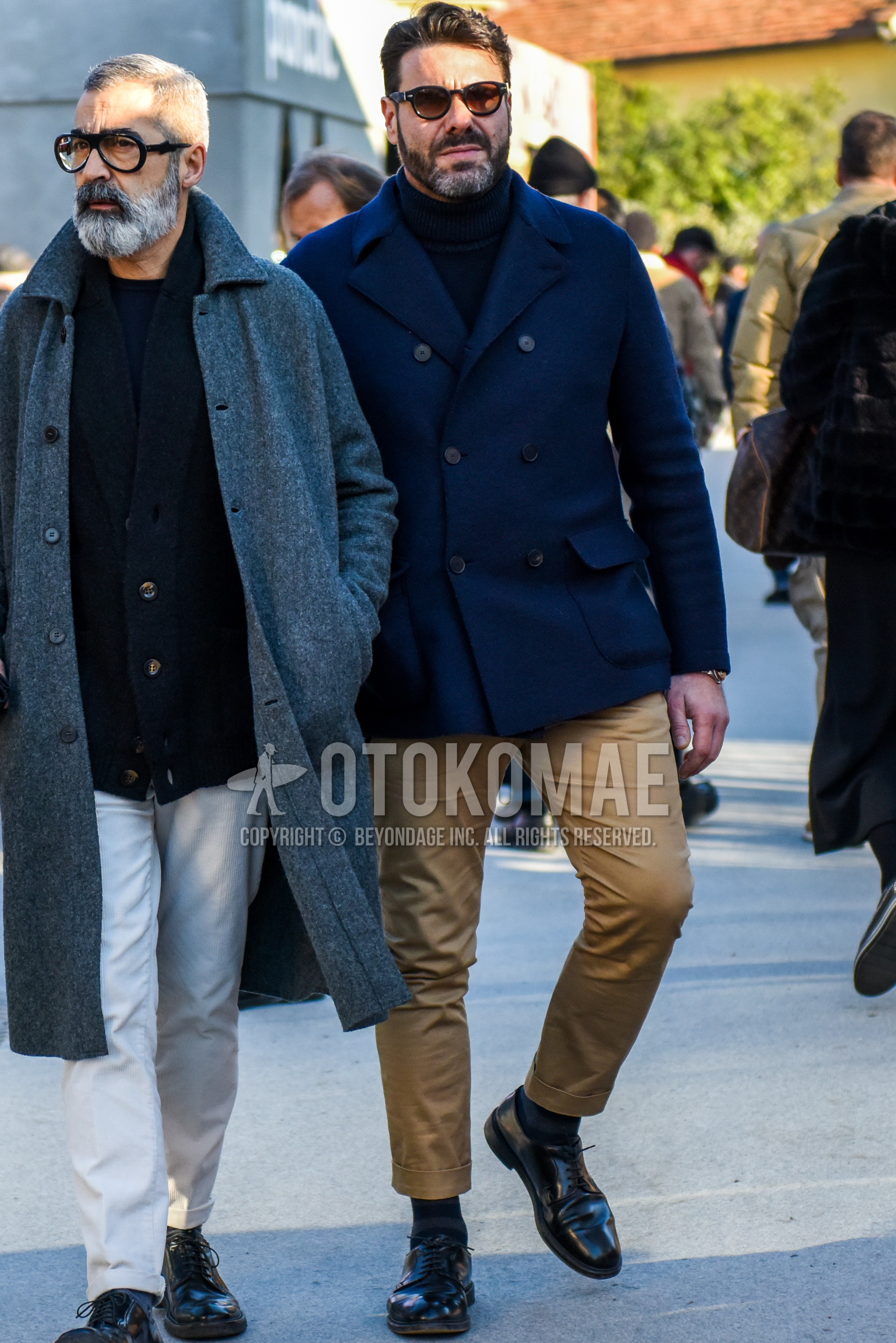 Men's winter outfit with plain sunglasses, navy plain p coat, beige plain chinos, dark gray horizontal stripes socks, black plain toe leather shoes.