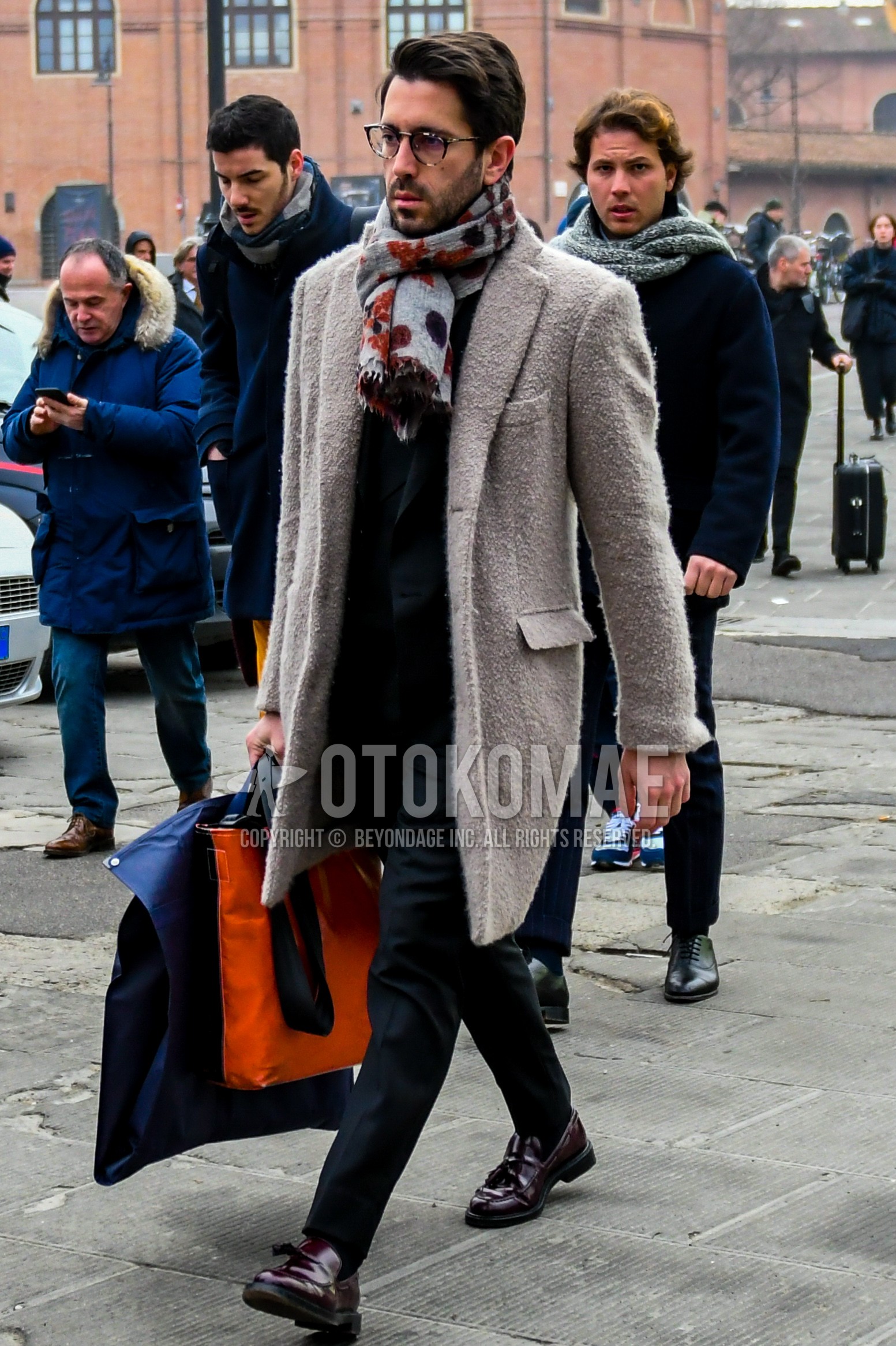 Men's autumn winter outfit with plain glasses, multi-color scarf scarf, beige plain chester coat, brown tassel loafers leather shoes, gray plain suit.