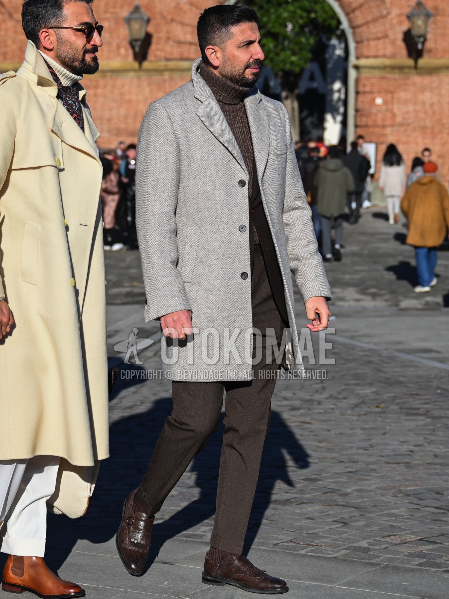 Men's autumn winter outfit with gray plain chester coat, brown plain turtleneck knit, brown plain ankle pants, brown plain slacks, brown plain socks, brown wing-tip shoes leather shoes.
