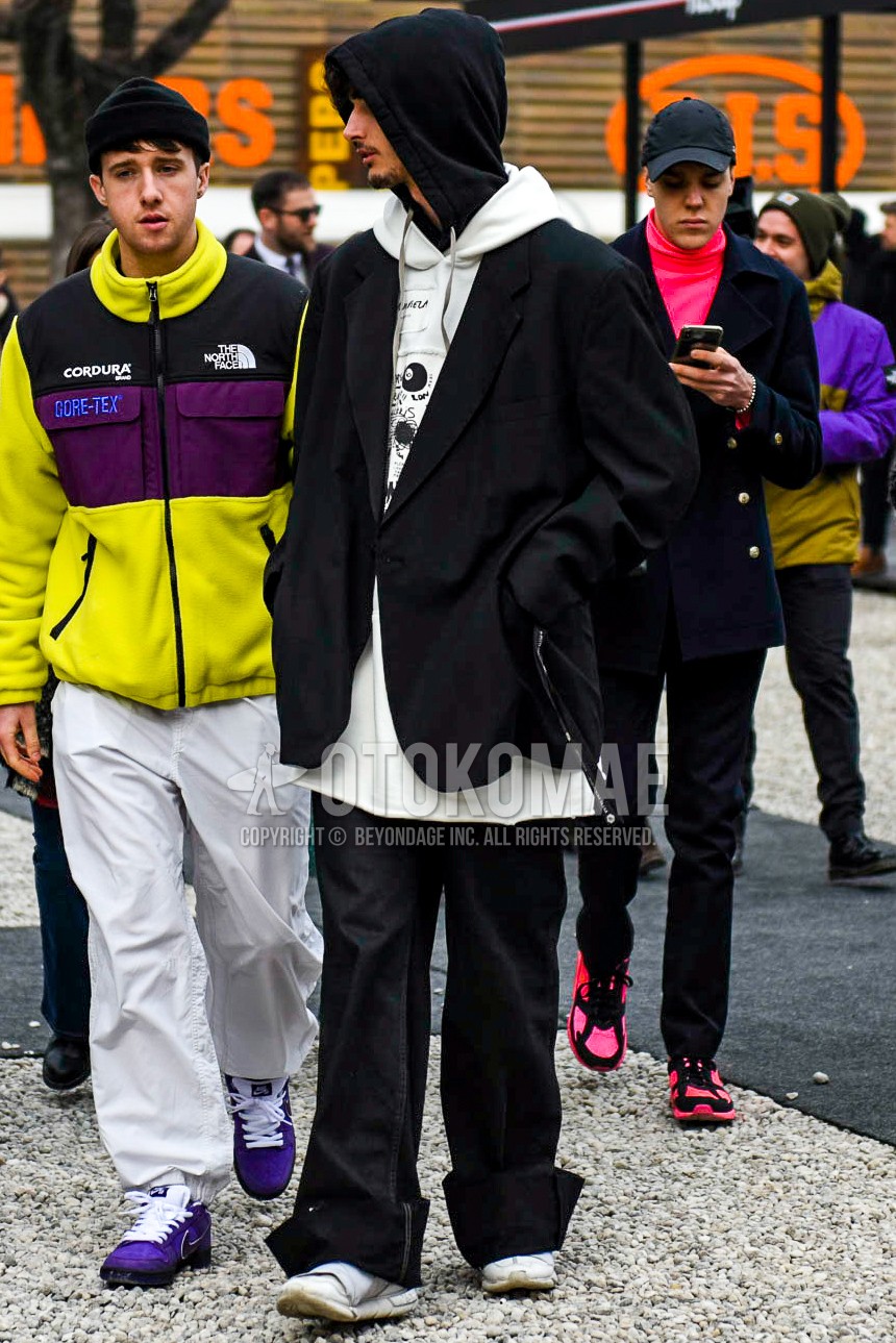 Men's winter outfit with black plain tailored jacket, white plain hoodie, black plain cotton pants, white low-cut sneakers.