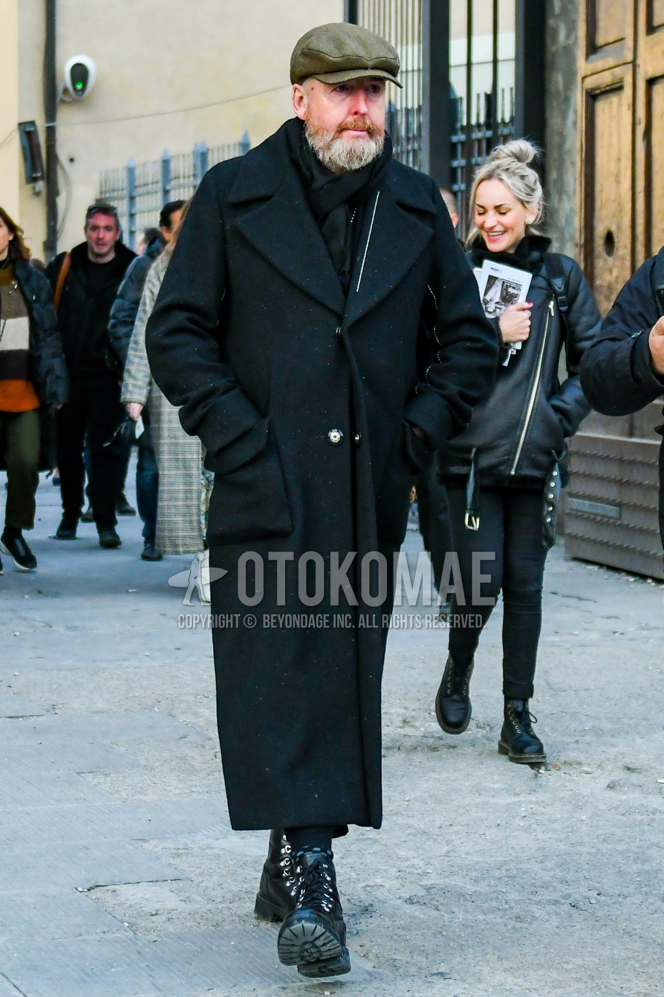 Men's winter outfit with gray plain cap, black plain scarf, black plain ulster coat, black work boots.