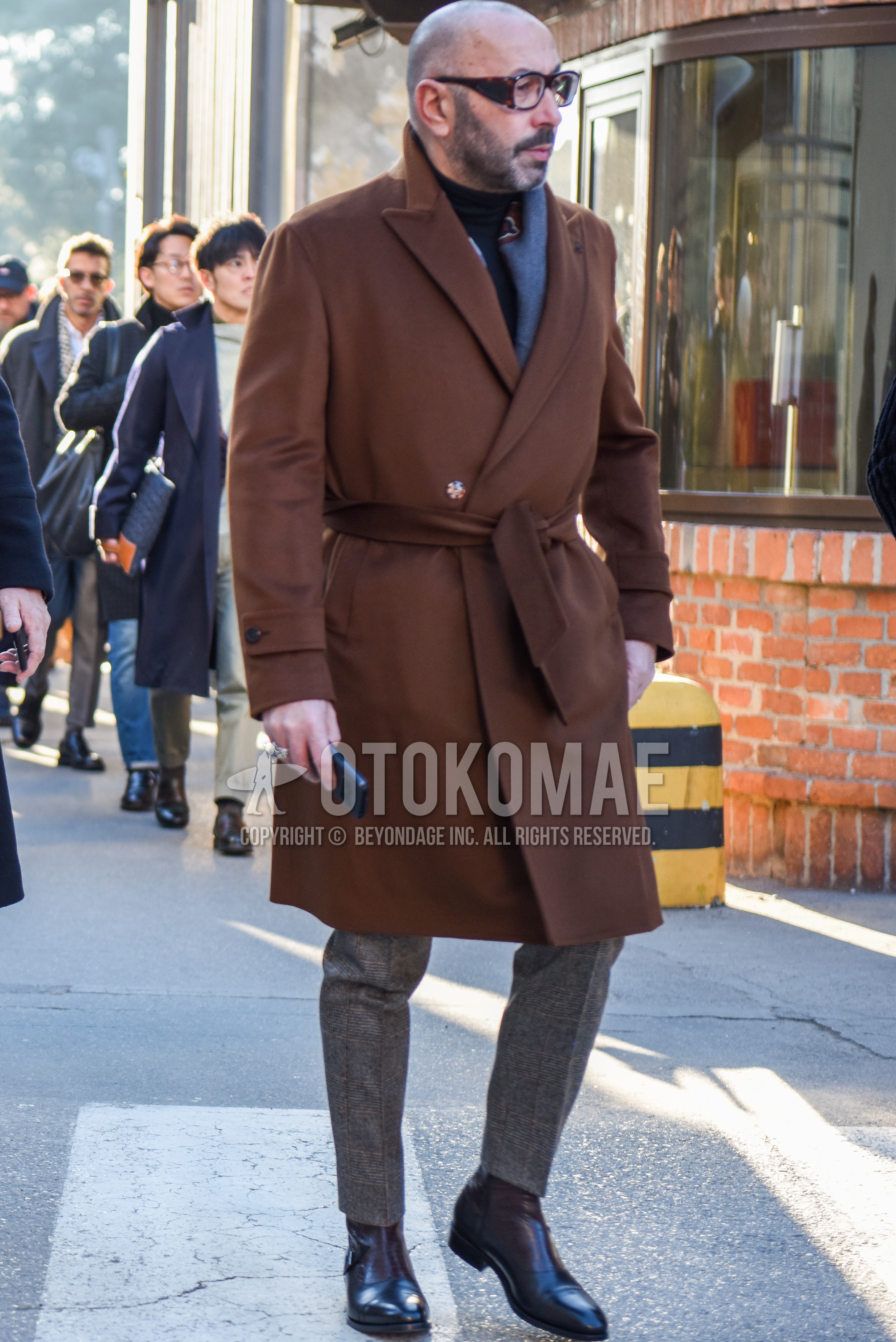 Men's autumn winter outfit with brown tortoiseshell glasses, gray plain scarf, brown plain chester coat, black plain turtleneck knit, gray plain slacks, brown black  boots.