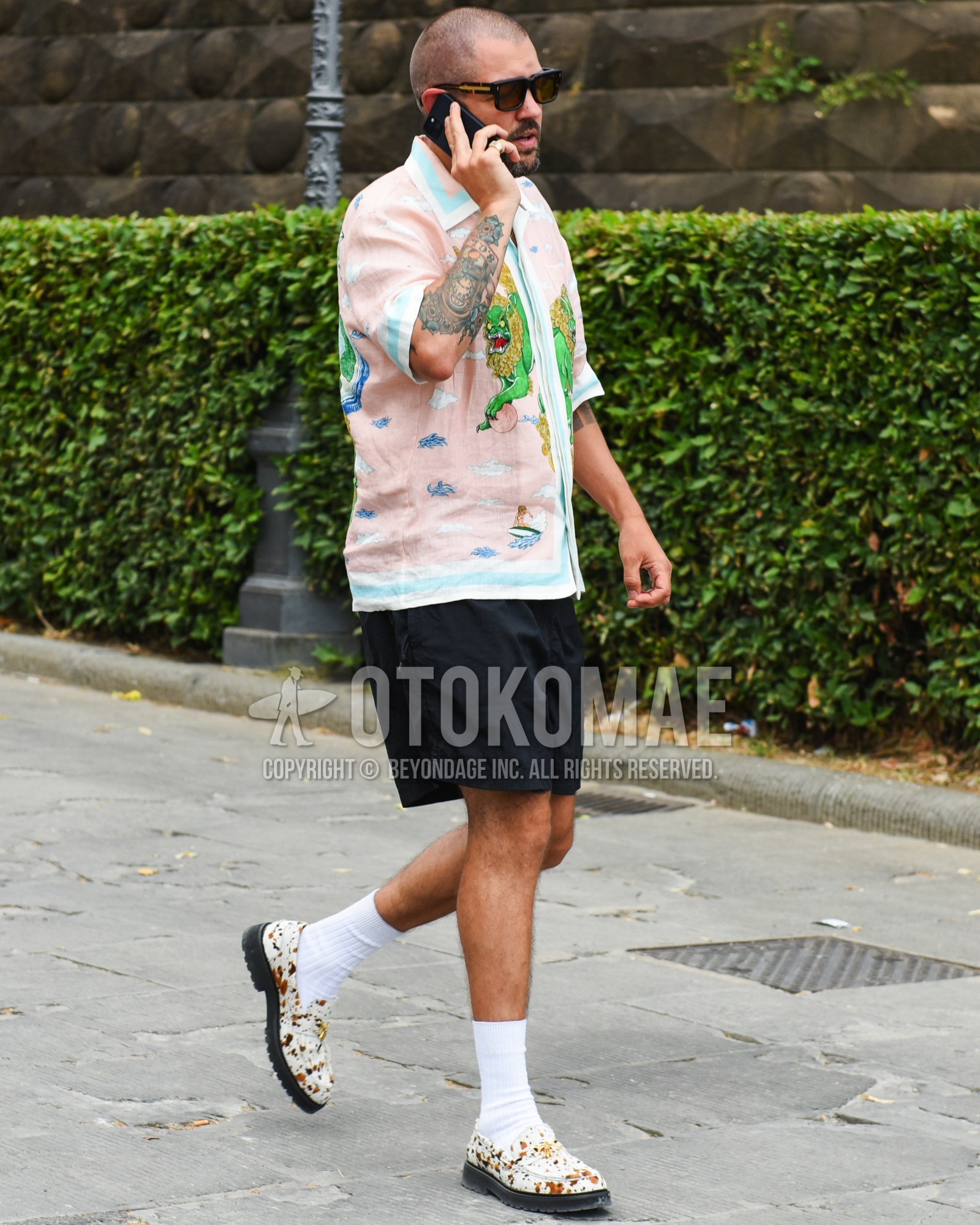 Men's spring summer outfit with black plain sunglasses, pink tops/innerwear shirt, black plain short pants, white plain socks, white coin loafers leather shoes.