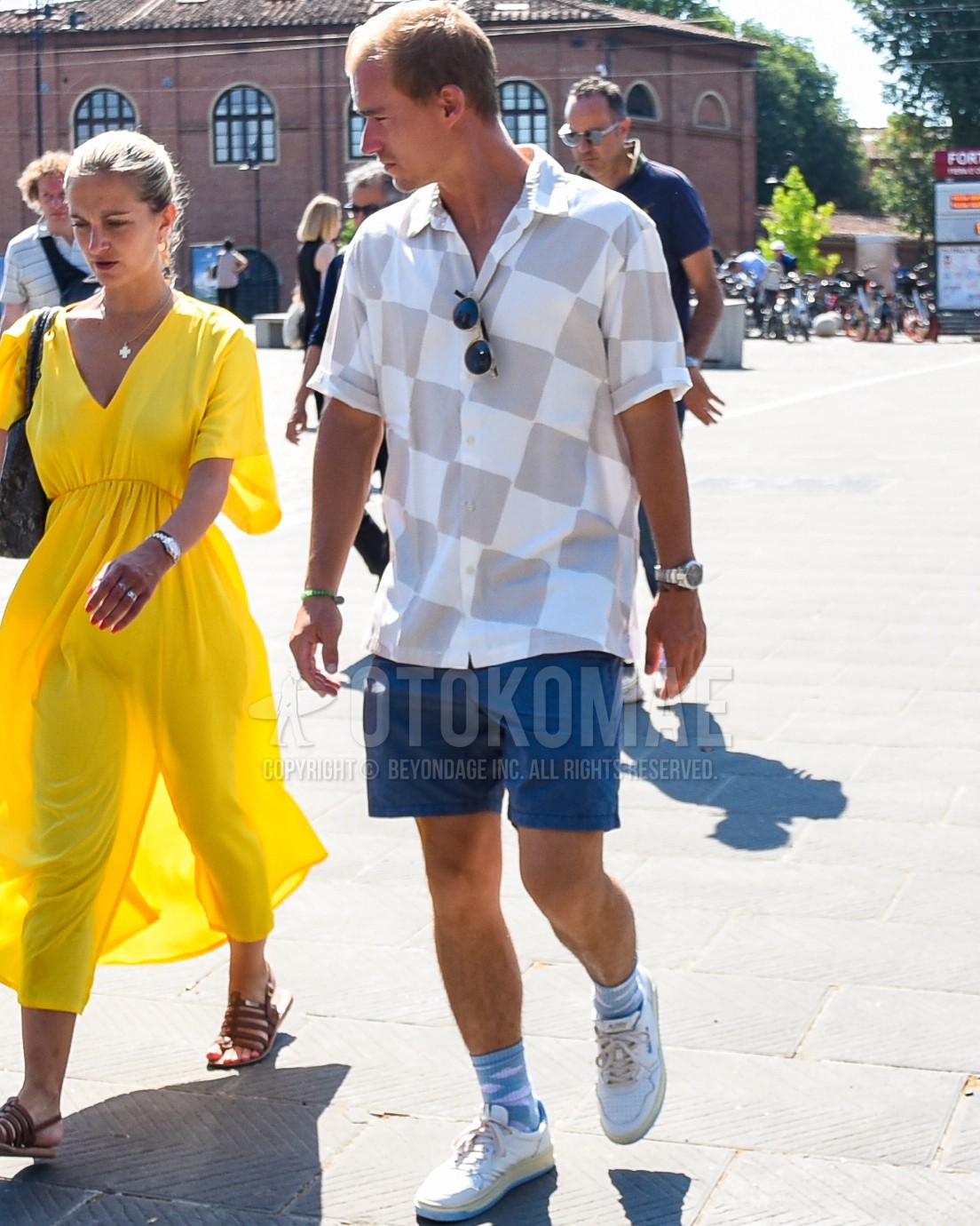 Men's spring summer outfit with gray check shirt, blue plain short pants,  light blue dots socks, white low-cut sneakers.