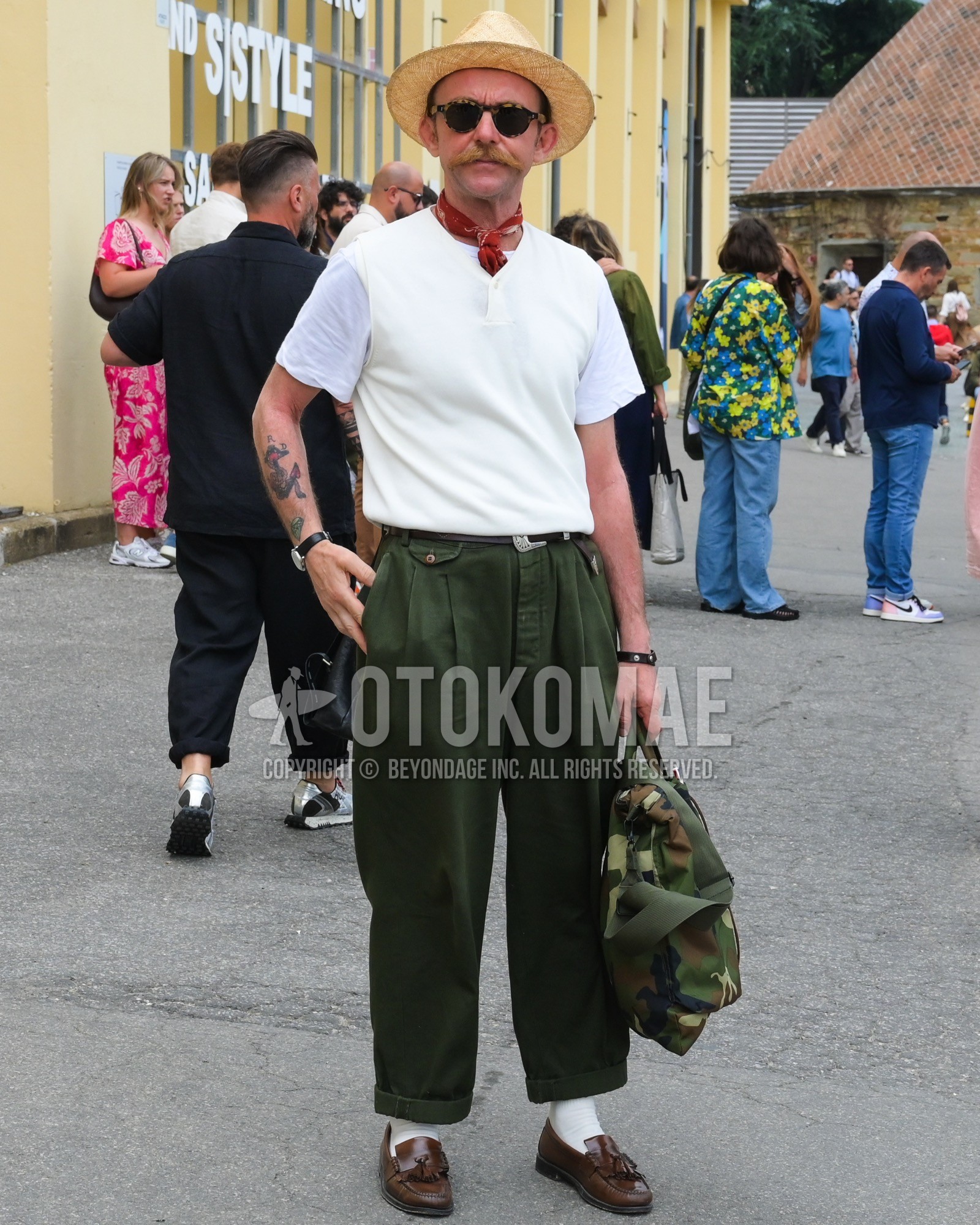 Men's spring summer outfit with beige plain hat, black plain sunglasses, red whole pattern bandana/neckerchief, white plain t-shirt, brown plain leather belt, olive green plain pleated pants, white plain socks, brown tassel loafers leather shoes, olive green camouflage briefcase/handbag.