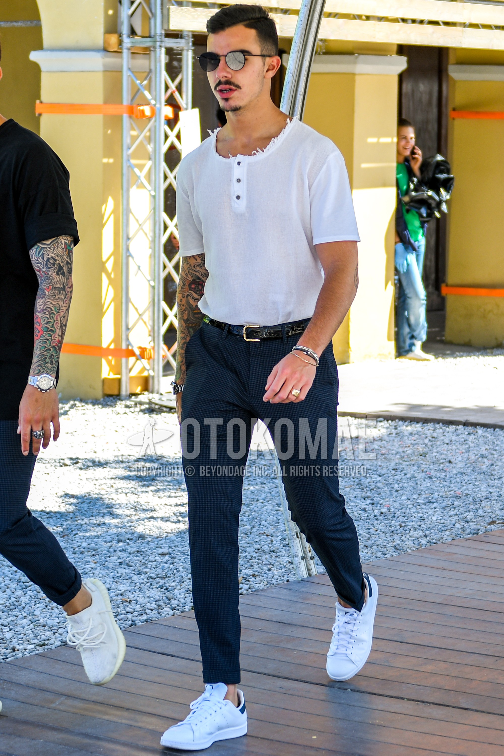 Men's summer outfit with plain sunglasses, white plain t-shirt, black plain leather belt, navy check slacks, white low-cut sneakers.
