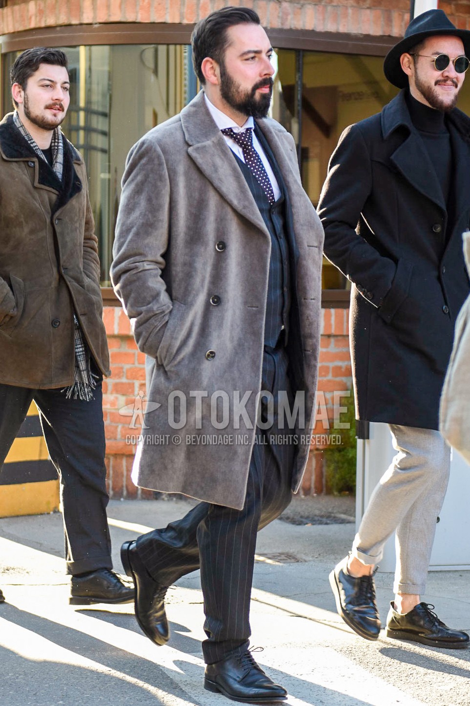 Men's winter outfit with gray plain ulster coat, white plain shirt, black plain toe leather shoes, gray stripes three-piece suit, black dots necktie.