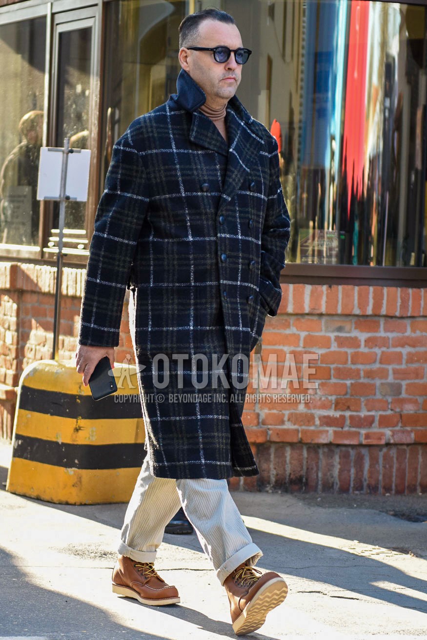 Men's autumn winter outfit with black plain sunglasses, navy check ulster coat, white plain winter pants (corduroy,velour), brown work boots.