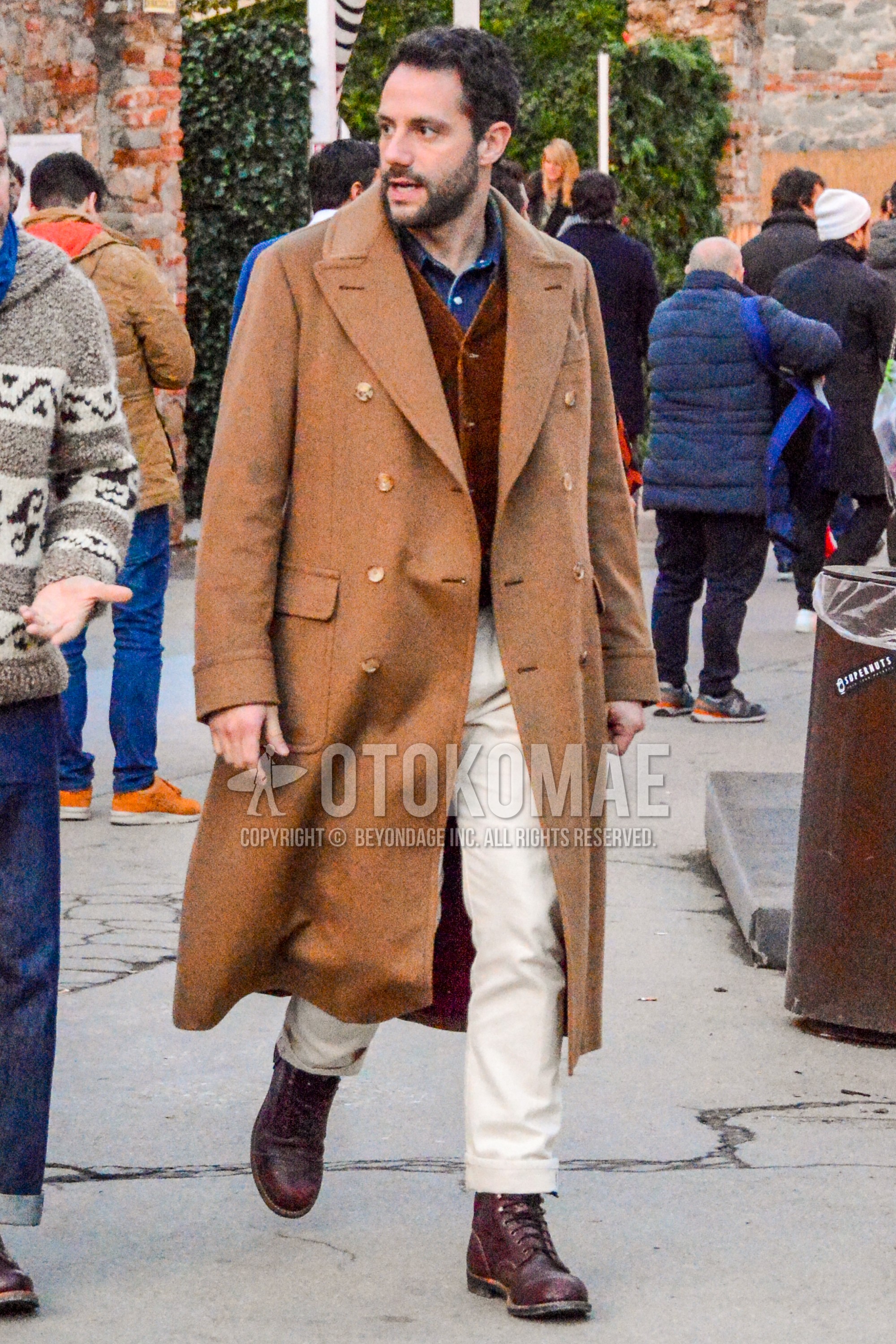Men's winter outfit with brown plain chester coat, brown plain gilet, blue plain denim shirt/chambray shirt, white plain winter pants (corduroy,velour), brown work boots.