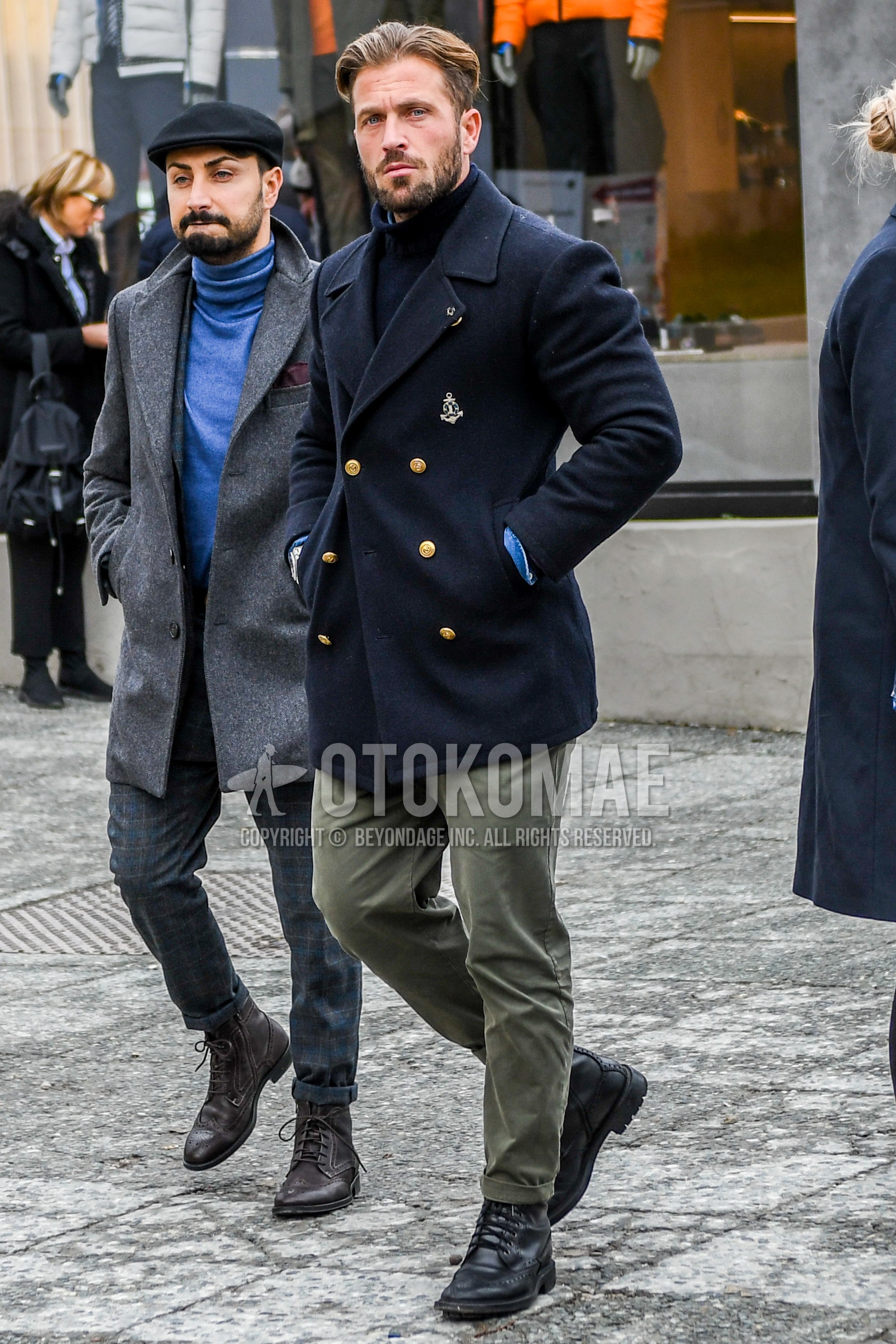 Men's winter outfit with navy plain tailored jacket, navy plain turtleneck knit, olive green plain chinos, black country boots.