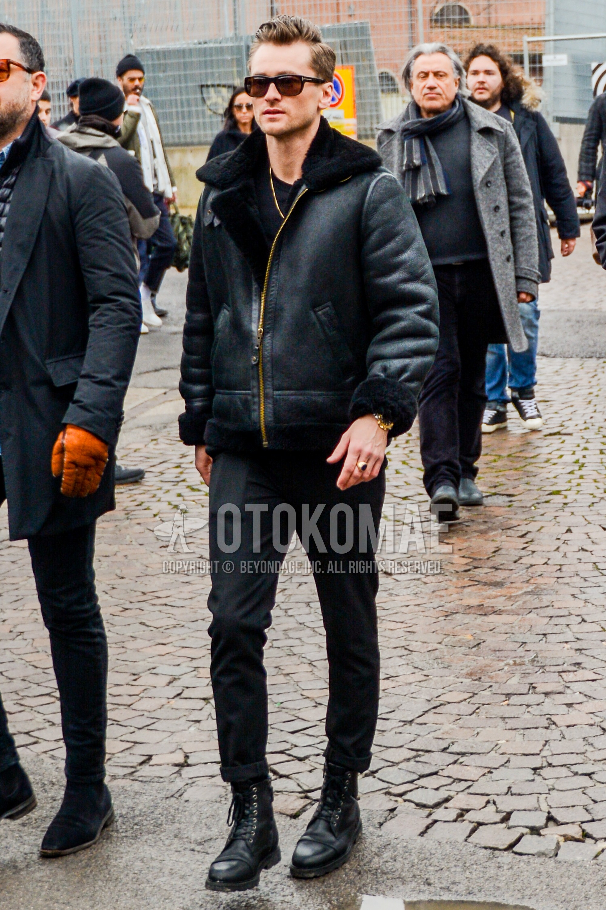 Men's winter outfit with plain sunglasses, black plain leather jacket, black plain sweater, black plain cotton pants, black  boots.