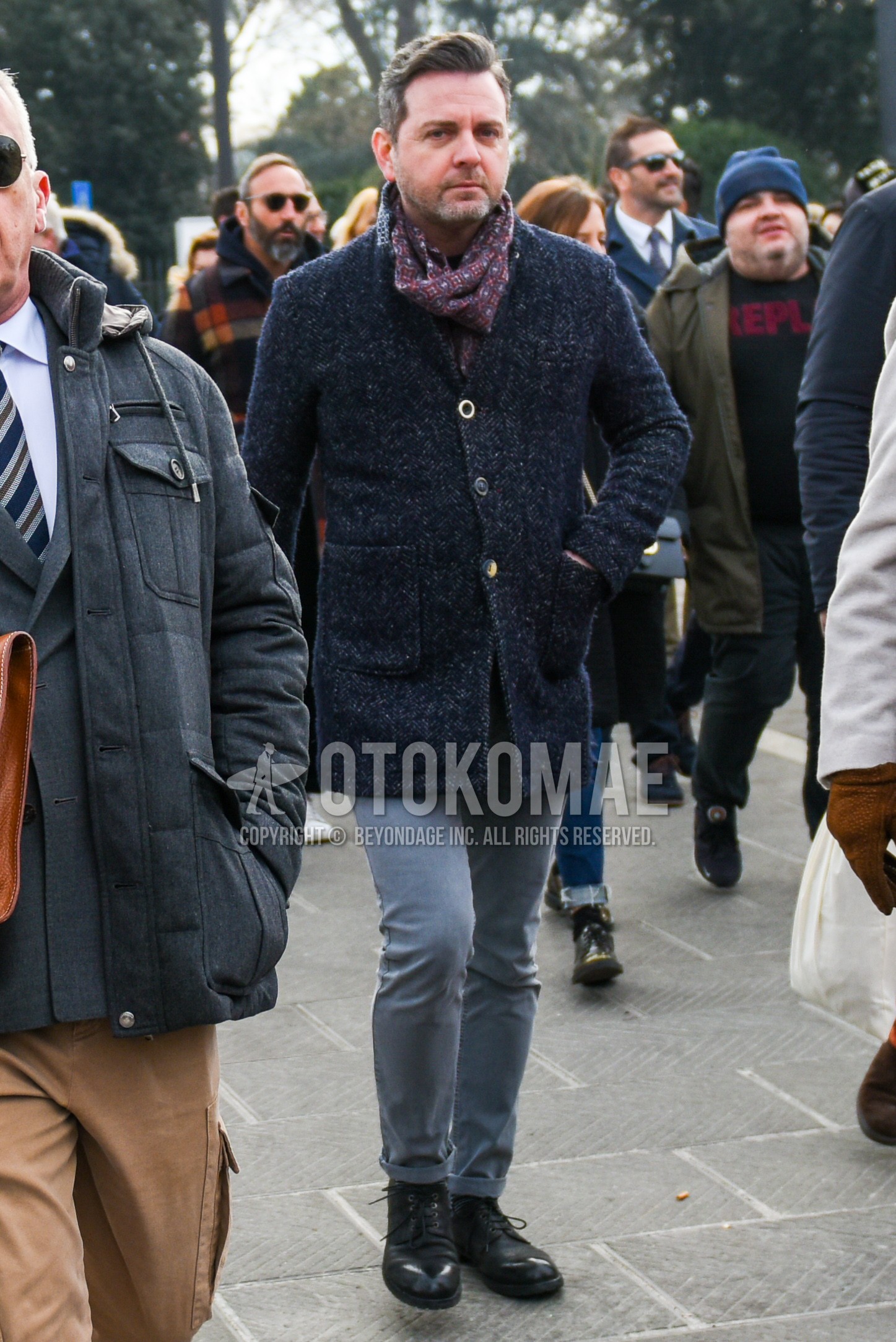 Men's autumn winter outfit with multi-color scarf scarf, gray outerwear chester coat, gray plain denim/jeans, black plain toe leather shoes.