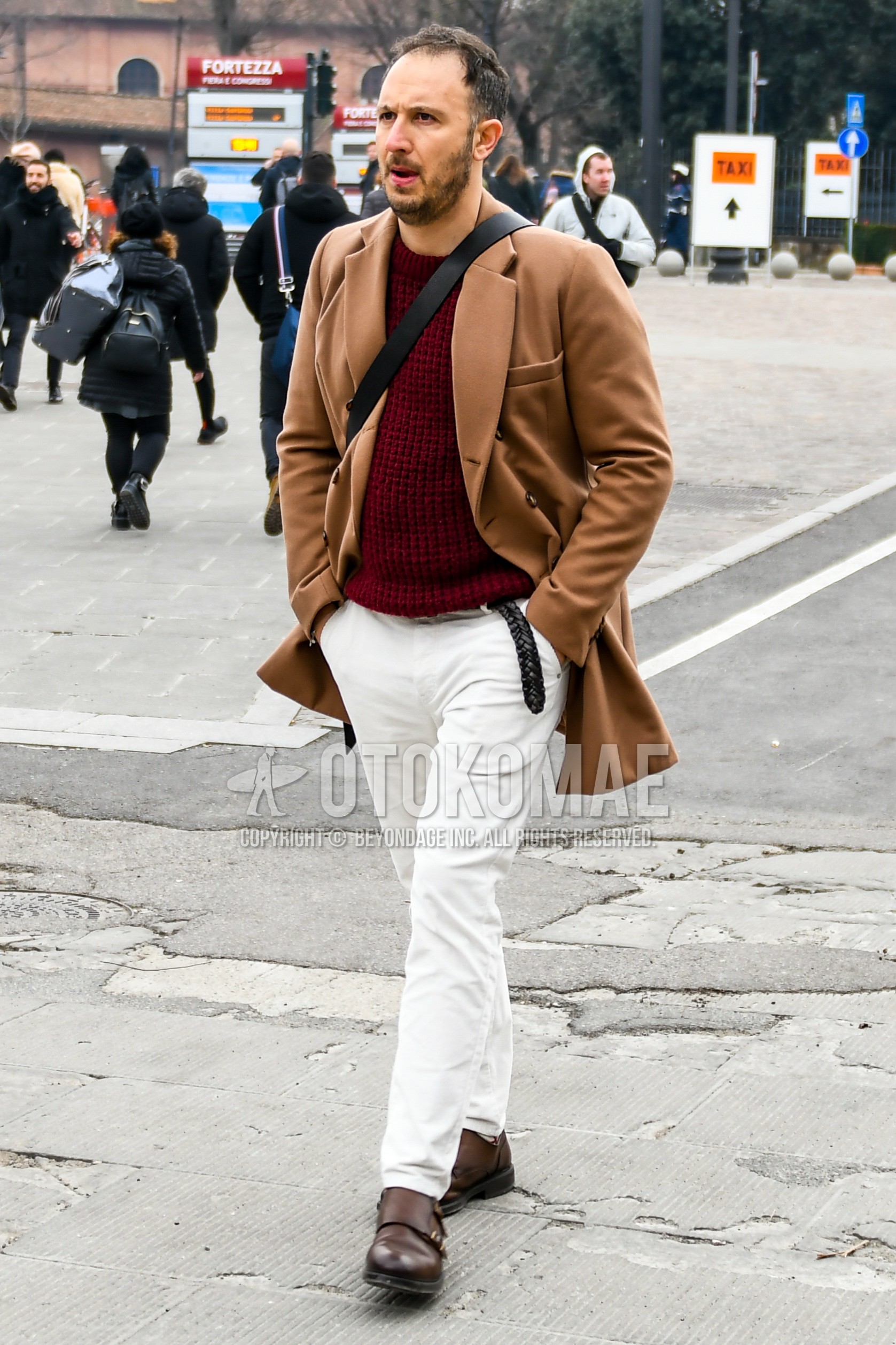 Men's autumn winter outfit with beige plain chester coat, red plain sweater, black plain leather belt, white plain cotton pants, brown monk shoes leather shoes.