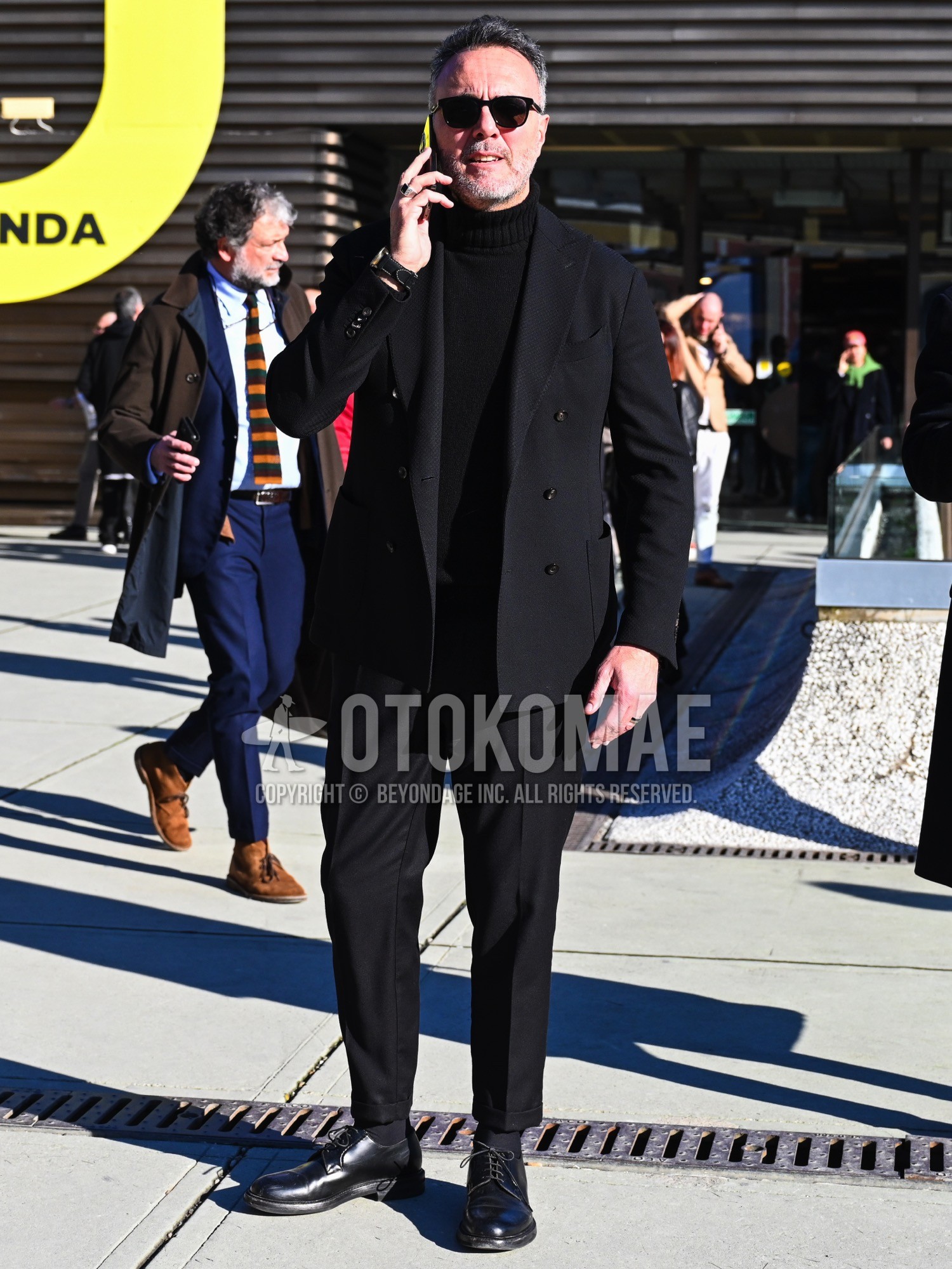Men's spring autumn winter outfit with black plain sunglasses, black plain turtleneck knit, black plain socks, black plain toe leather shoes, black plain suit.