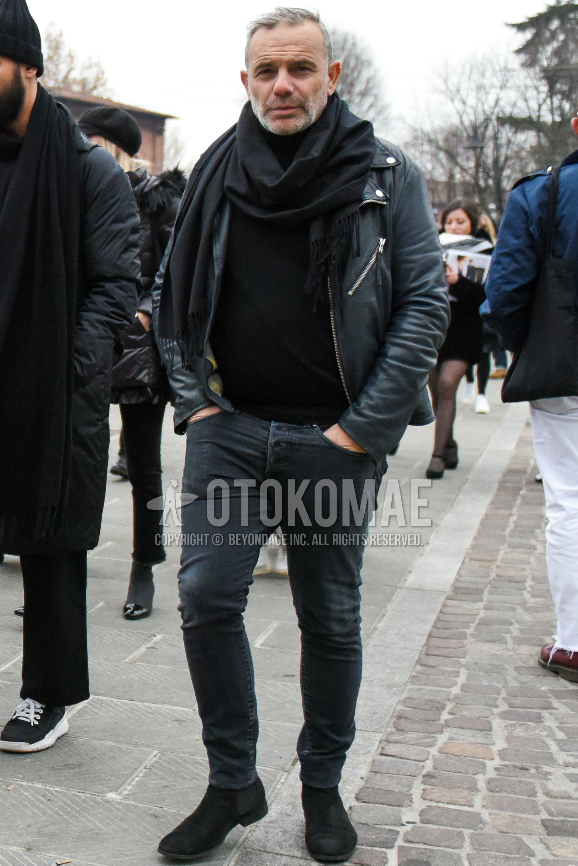 Men's winter outfit with black plain scarf, black plain sweater, black plain denim/jeans, black side-gore boots.