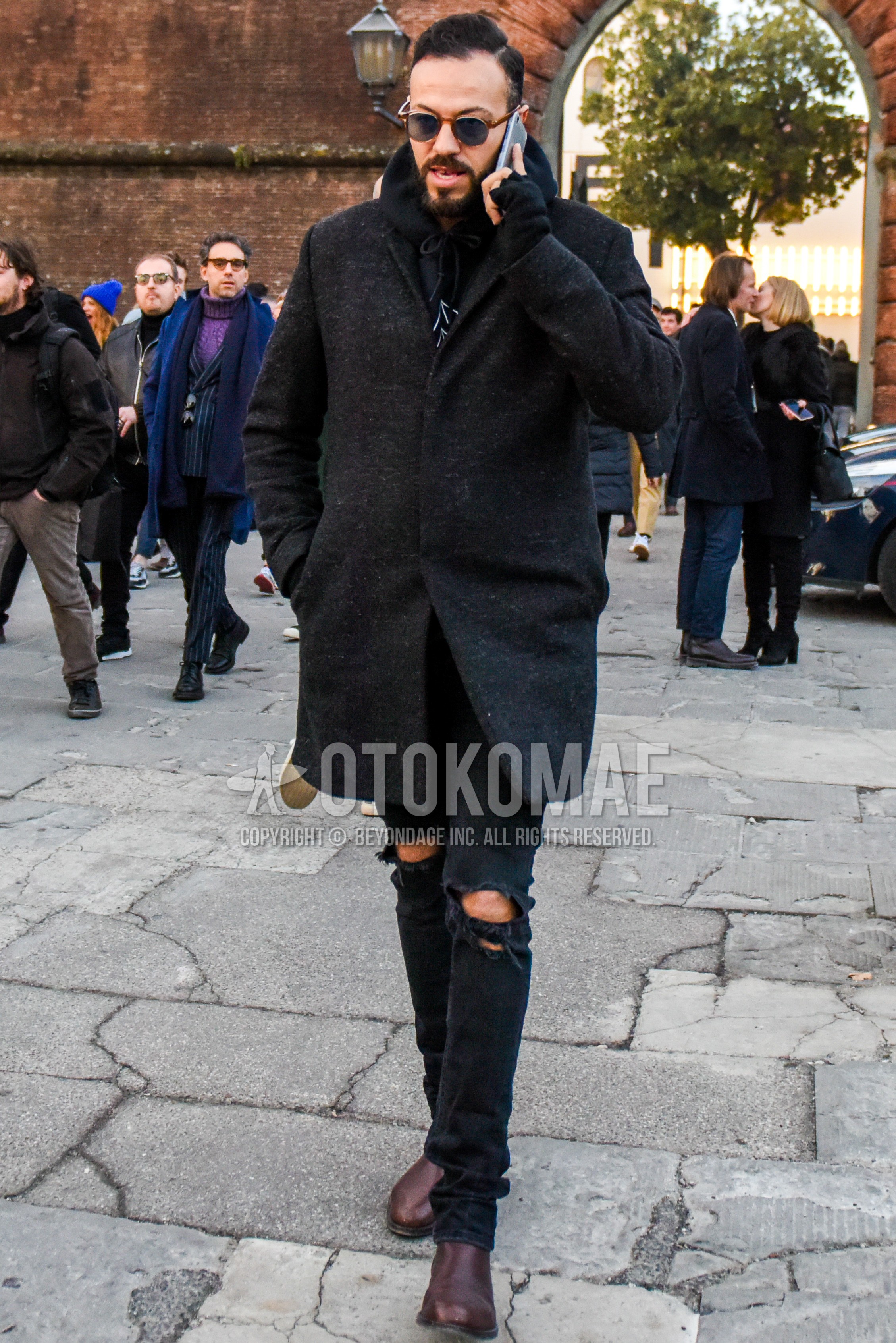 Men's autumn winter outfit with plain sunglasses, black plain chester coat, black plain hoodie, black plain damaged jeans, brown  boots.