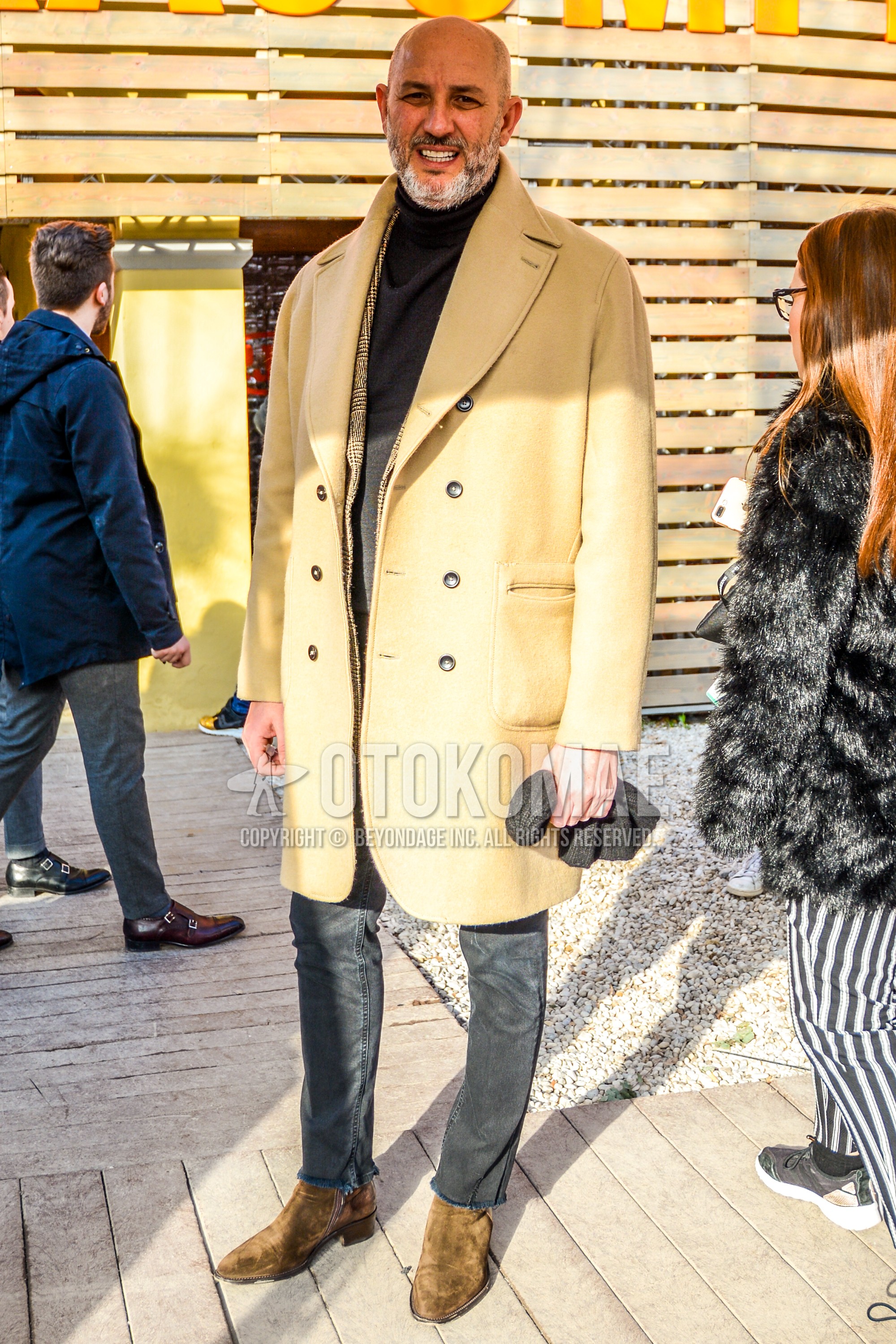 Men's autumn winter outfit with beige plain chester coat, gray plain turtleneck knit, gray plain denim/jeans, beige side-gore boots.
