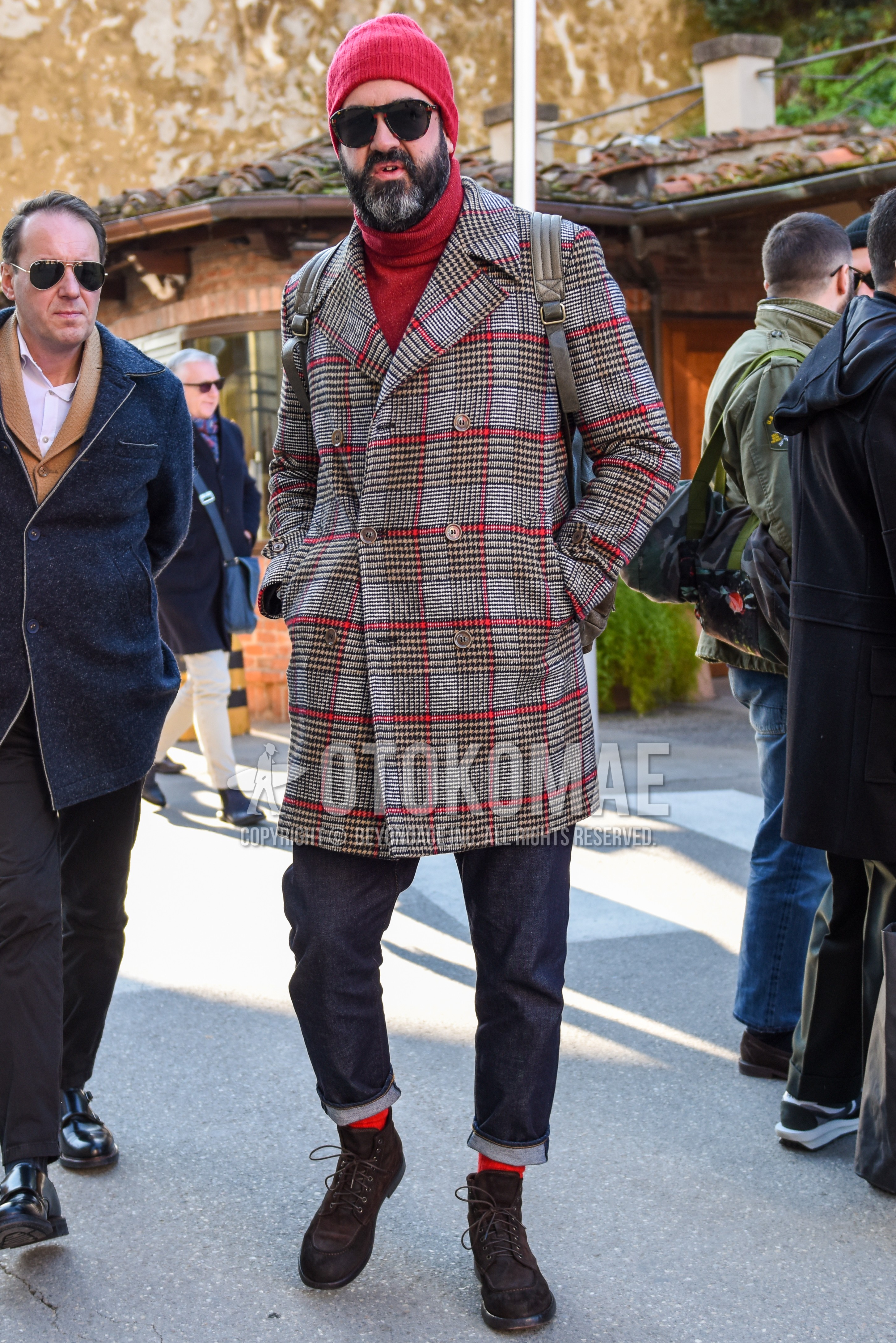 Men's autumn winter outfit with red plain knit cap, brown tortoiseshell sunglasses, gray red check ulster coat, red plain turtleneck knit, navy plain denim/jeans, red plain socks, brown  boots.
