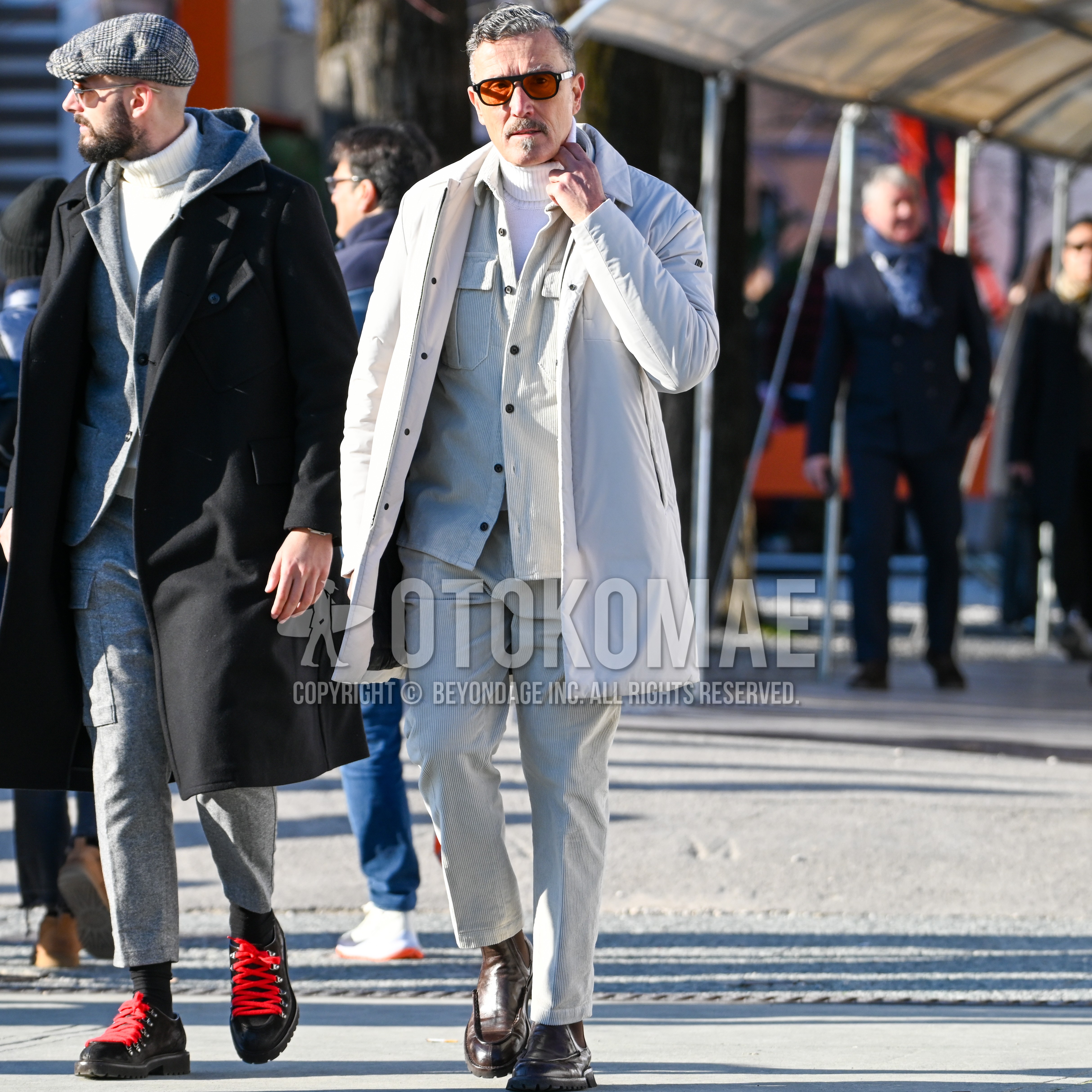 Men's autumn winter outfit with black plain sunglasses, white plain stenkarrer coat, beige plain shirt jacket, white plain turtleneck knit, beige plain winter pants (corduroy,velour), brown side-gore boots.