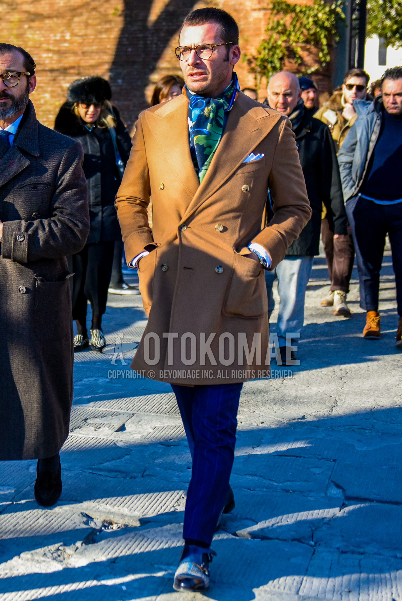 Men's winter outfit with plain glasses, multi-color plain scarf, brown plain tailored jacket, blue stripes slacks, multi-color monk shoes leather shoes.