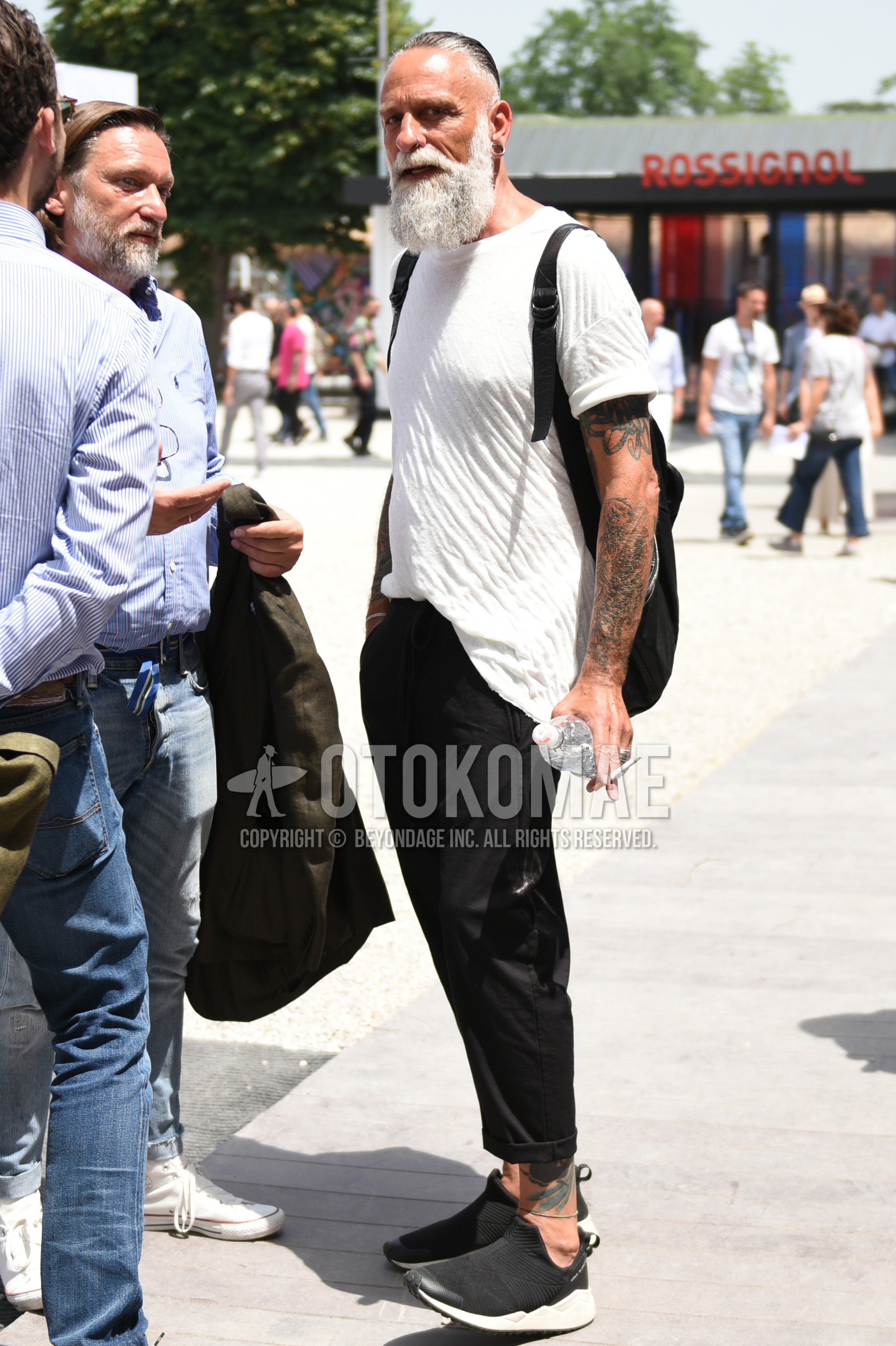 Men's summer outfit with white plain t-shirt, black plain cotton pants, black low-cut sneakers.