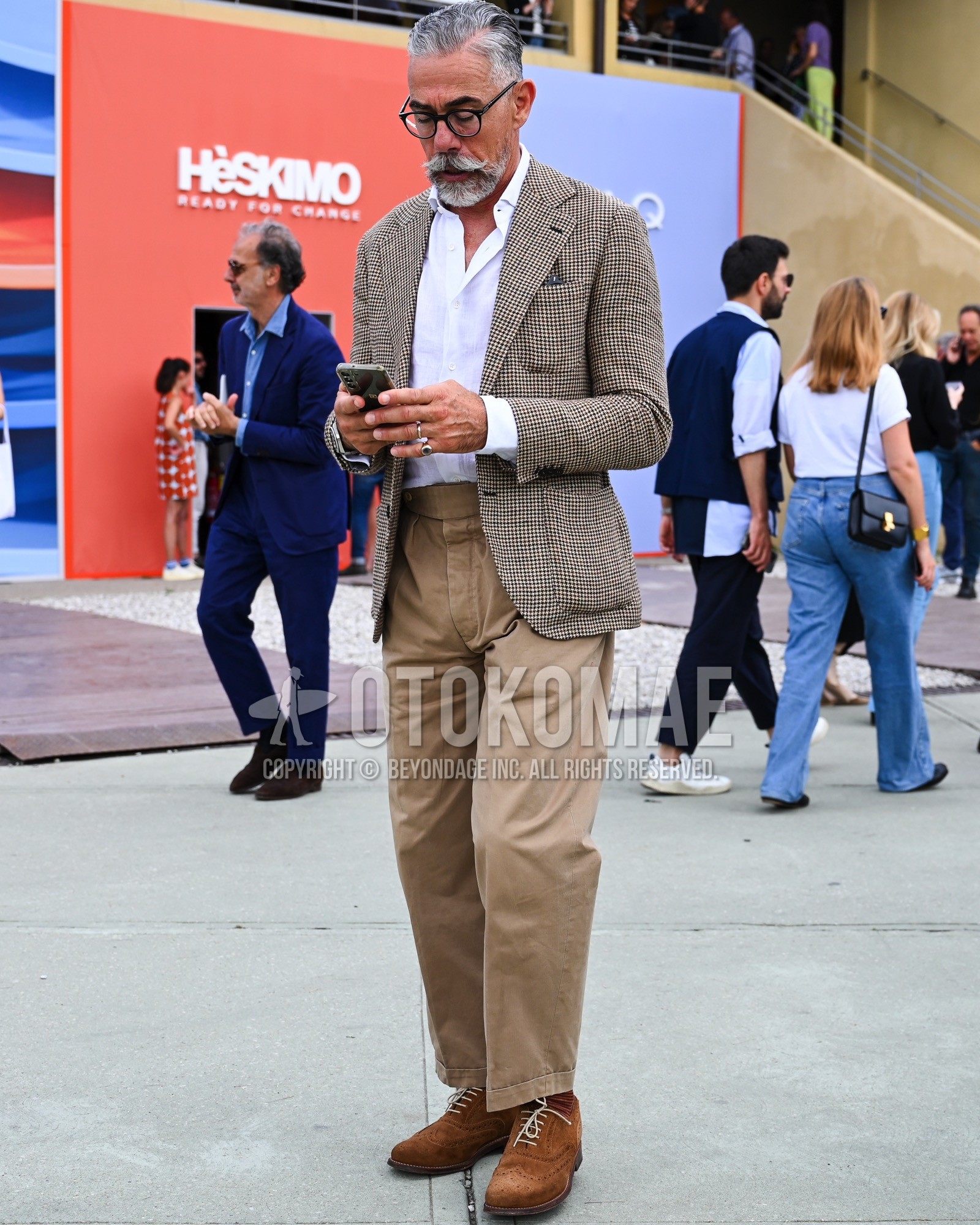 Men's spring summer autumn outfit with clear plain sunglasses, beige check tailored jacket, white plain shirt, beige plain slacks, brown plain toe leather shoes, brown suede shoes leather shoes.