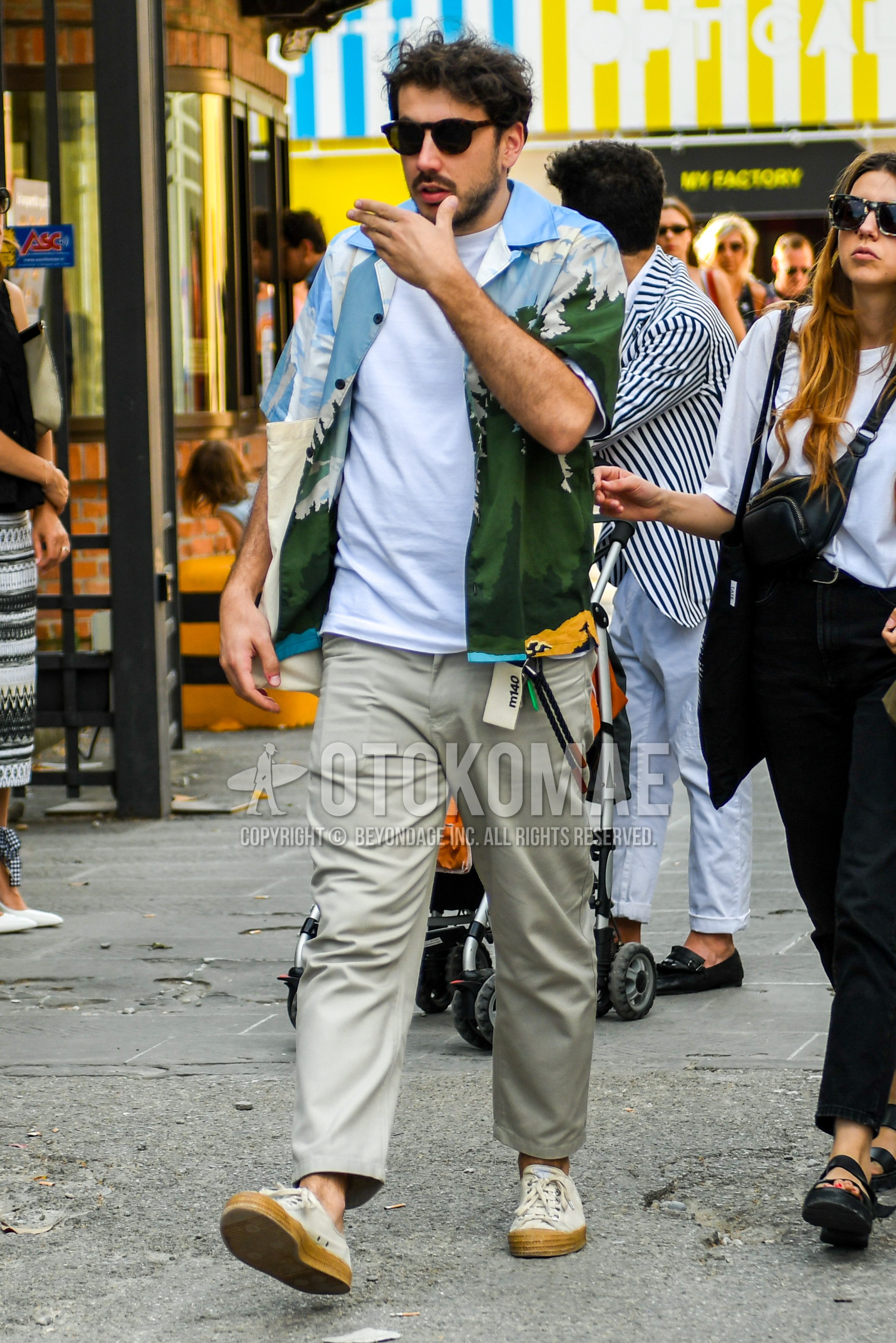 Men's summer outfit with plain sunglasses, multi-color tops/innerwear shirt, white plain t-shirt, gray plain ankle pants, beige low-cut sneakers.