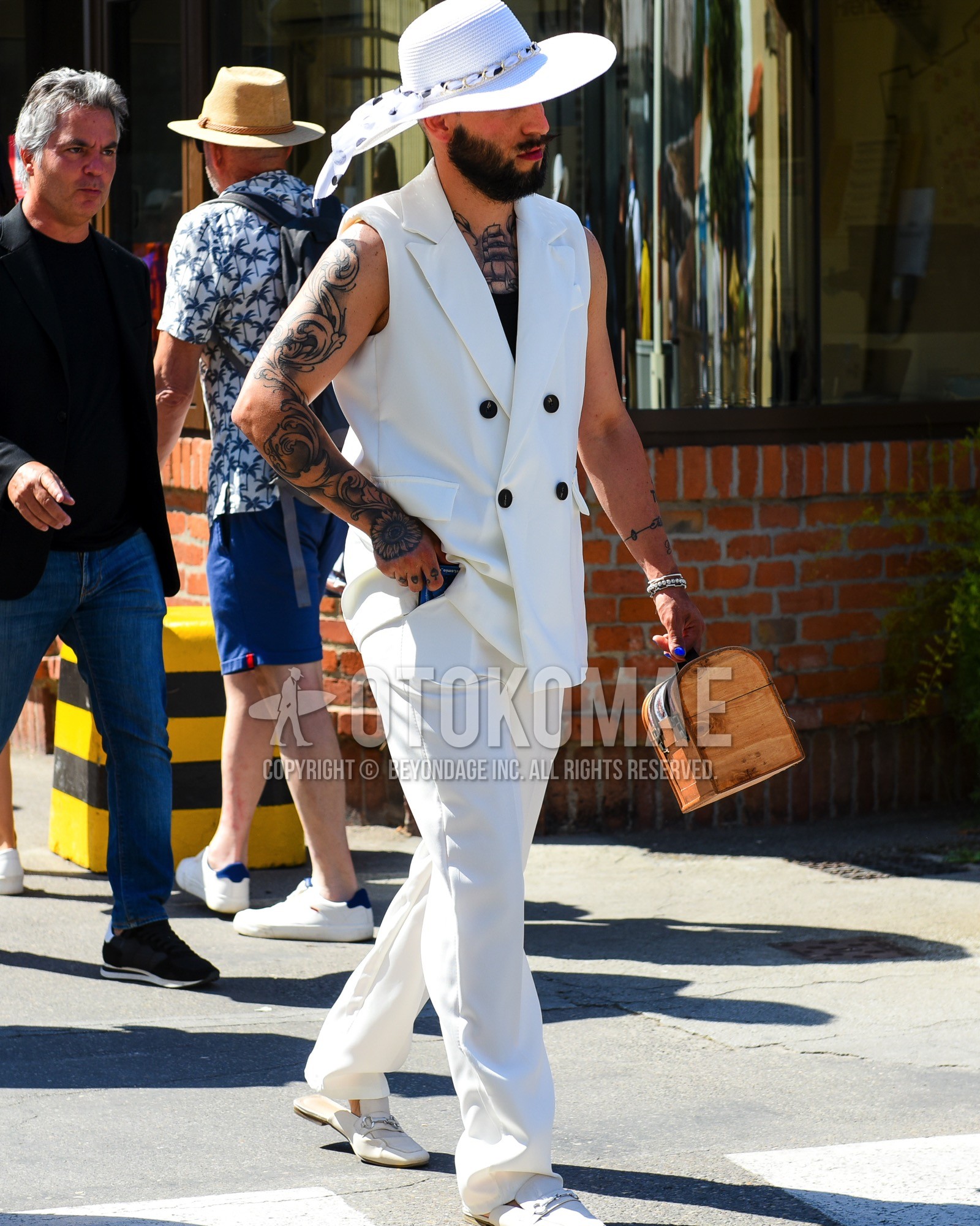 Men's spring summer outfit with white plain hat, white plain gilet, black plain tank top, white plain slacks, white bit loafers leather shoes, white  loafers leather shoes, brown plain briefcase/handbag.