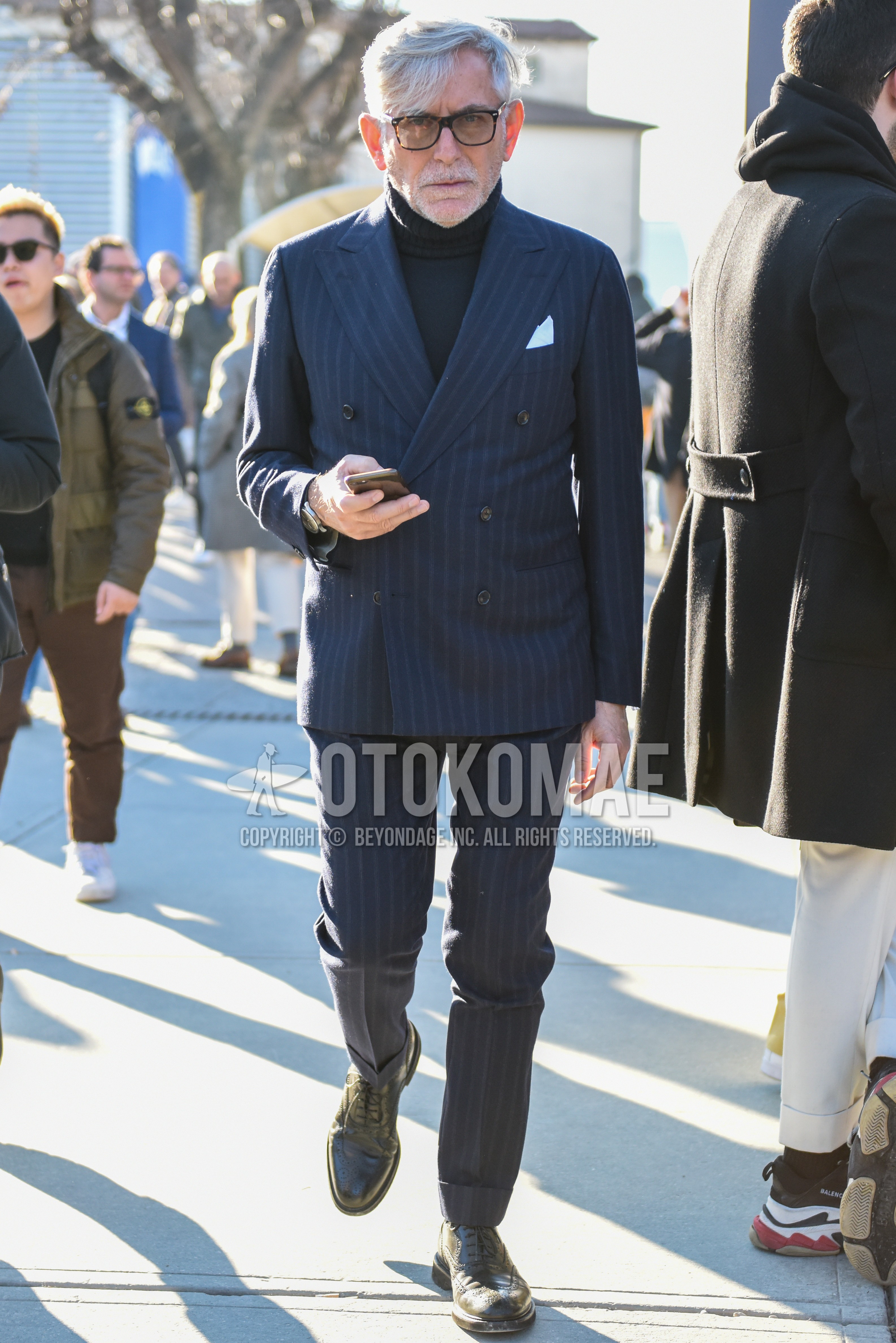 Men's spring autumn outfit with brown tortoiseshell sunglasses, dark gray plain turtleneck knit, black wing-tip shoes leather shoes, gray stripes suit.