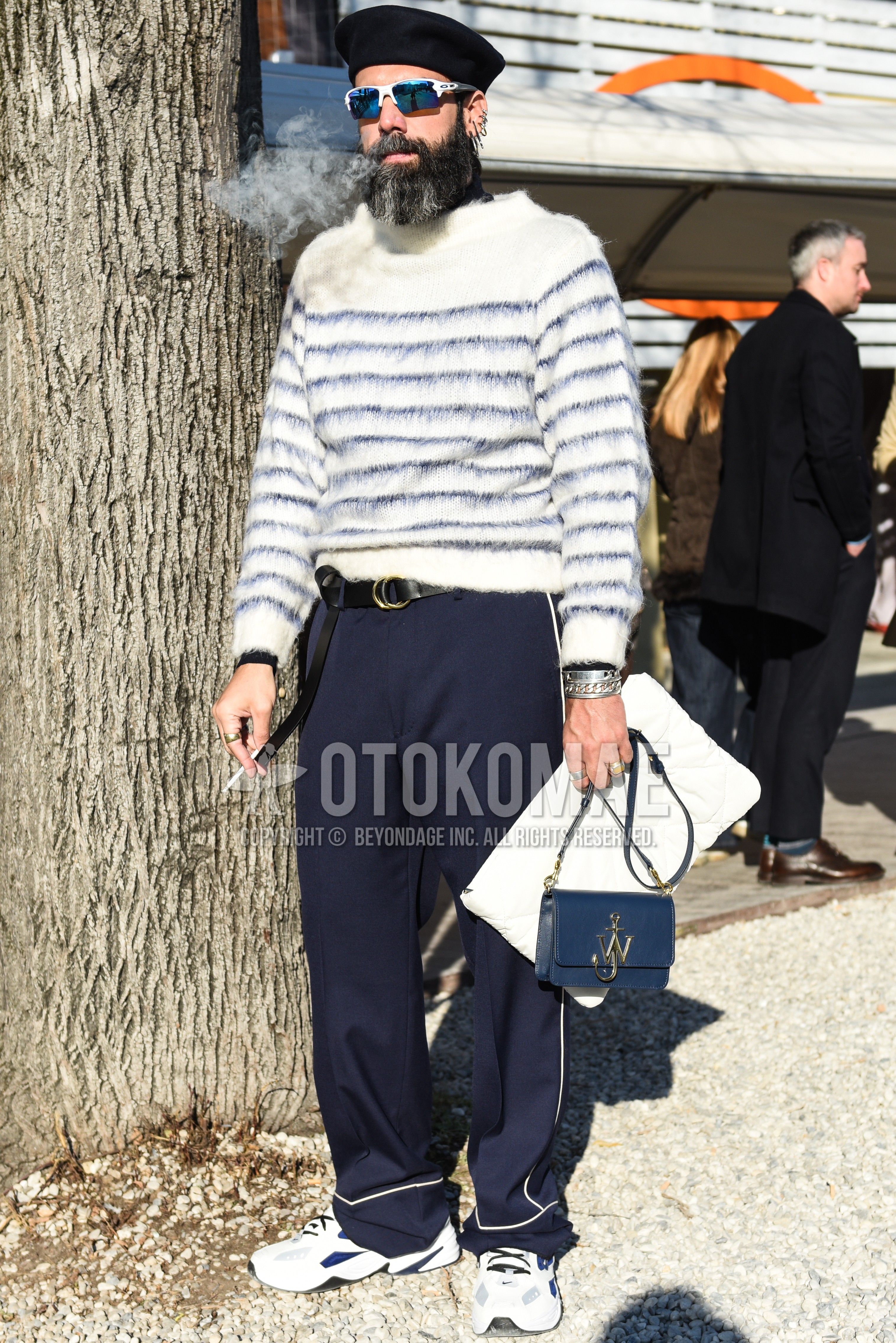 Men's spring autumn outfit with black plain cap, white plain sunglasses, white stripes sweater, black plain leather belt, gray plain slacks, white low-cut sneakers, navy plain shoulder bag.