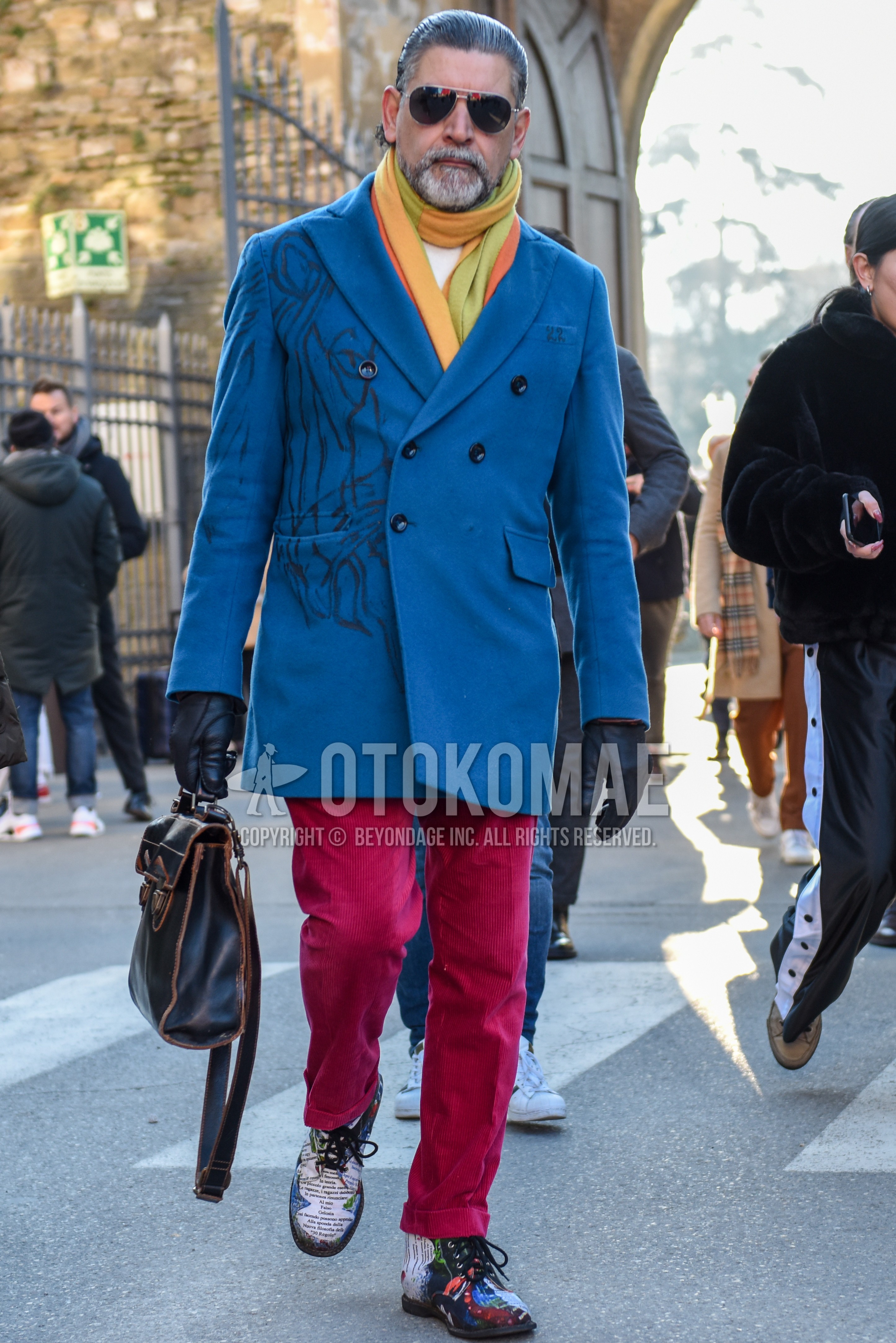 Men's autumn winter outfit with silver plain sunglasses, multi-color scarf scarf, blue plain chester coat, red plain slacks, multi-color  boots, brown plain briefcase/handbag.