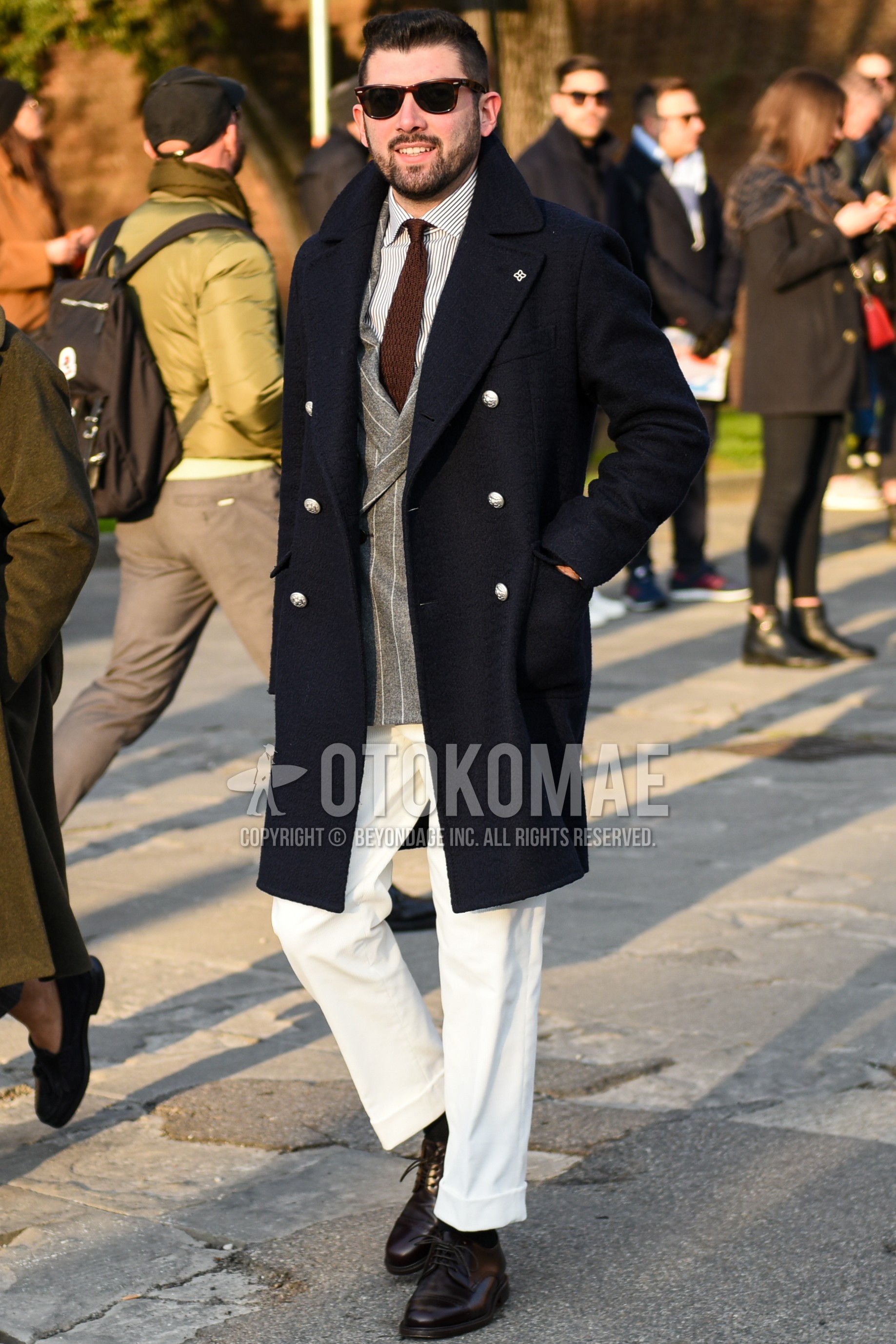Men's autumn winter outfit with navy plain ulster coat, gray stripes tailored jacket, white stripes shirt, white plain cotton pants, brown plain toe leather shoes, brown plain knit tie.
