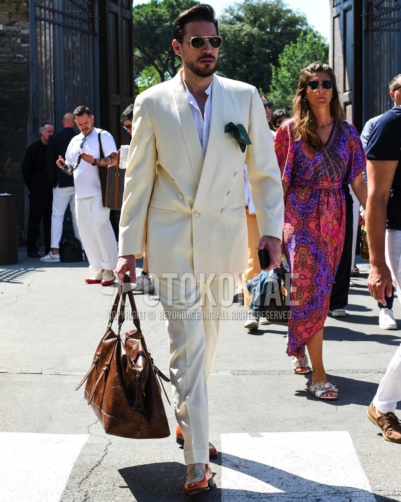 Men's spring summer outfit with gold plain sunglasses, white plain shirt, brown beige  loafers leather shoes, brown plain boston bag, white plain suit.