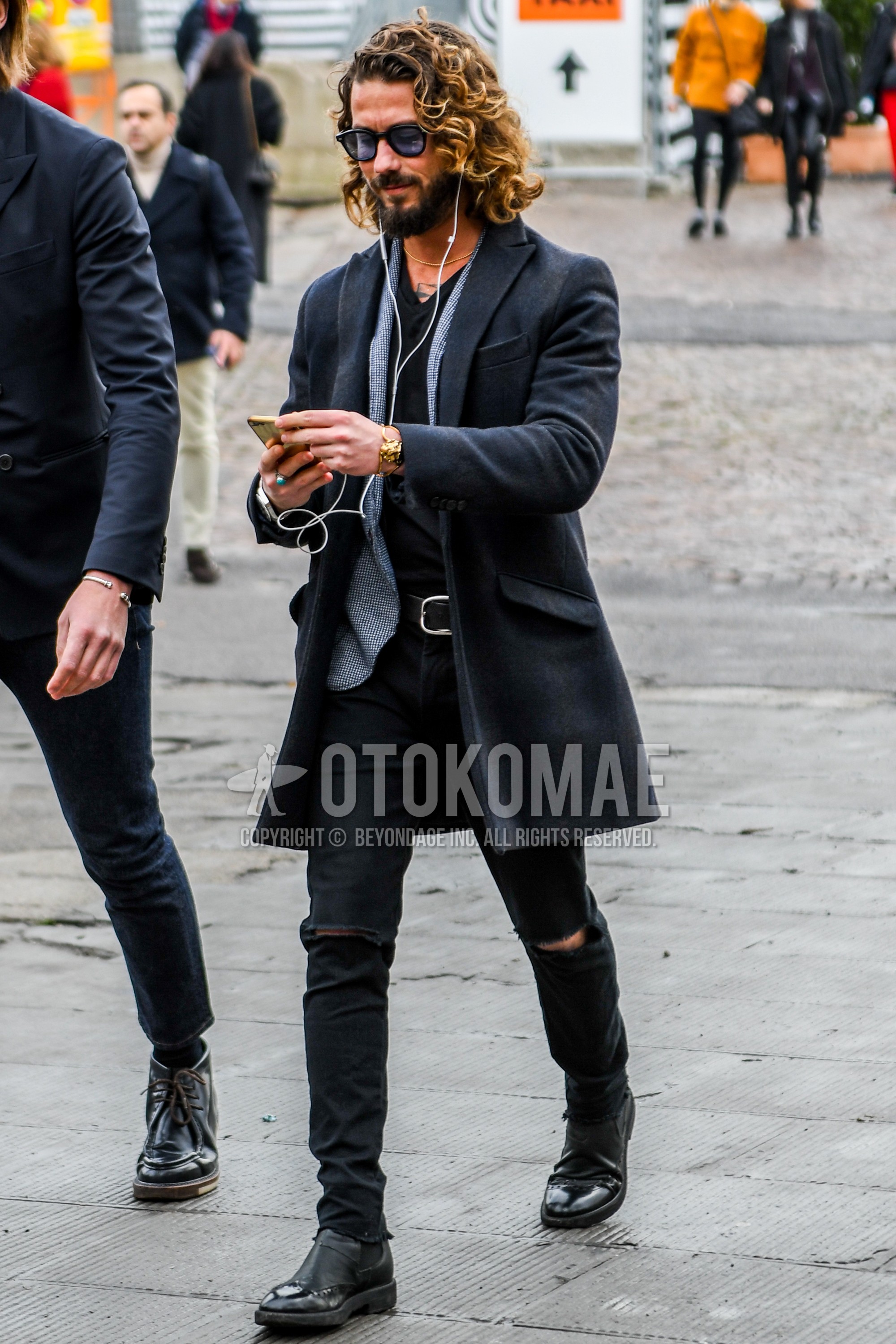 Men's autumn winter outfit with plain sunglasses, black plain chester coat, gray tops/innerwear tailored jacket, black plain t-shirt, black plain damaged jeans, black side-gore boots.