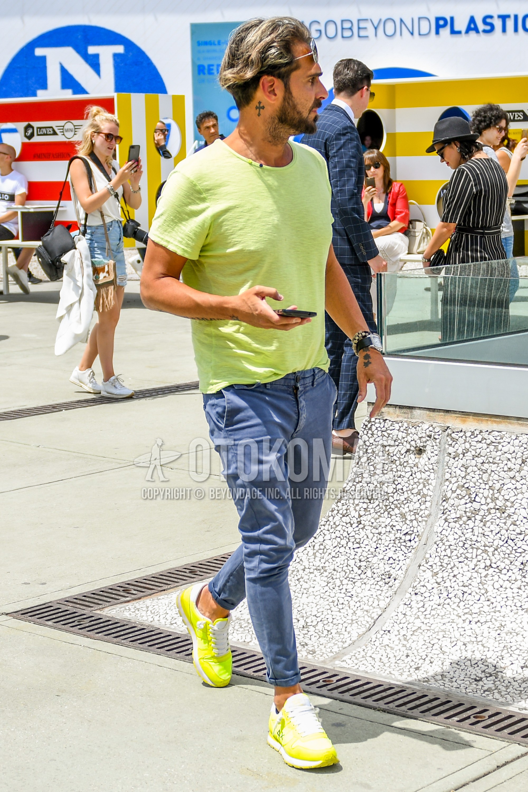 Men's summer outfit with plain sunglasses, yellow plain t-shirt, blue plain cotton pants, yellow low-cut sneakers.