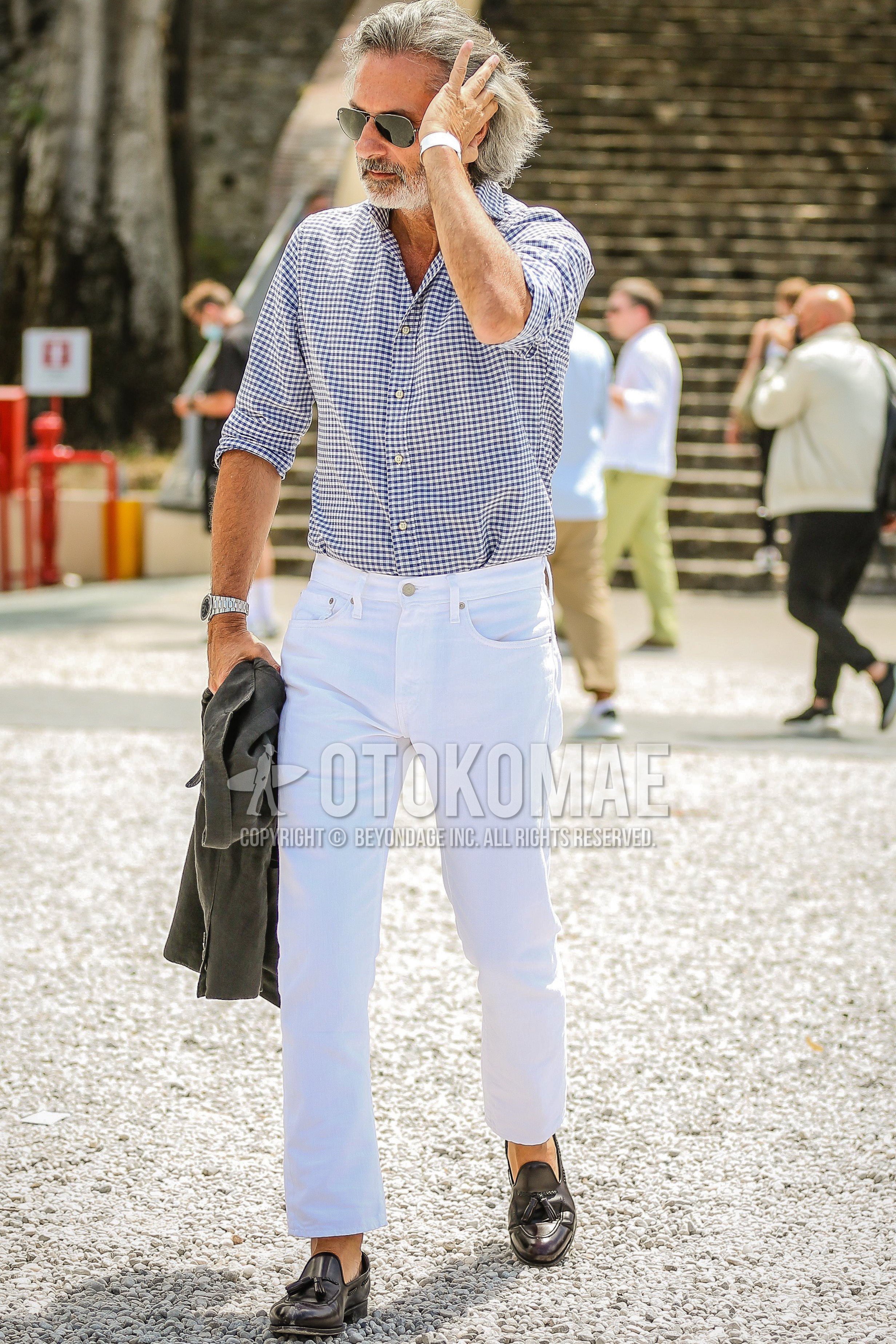 Men's spring summer outfit with silver plain sunglasses, light blue check shirt, white plain denim/jeans, black tassel loafers leather shoes.