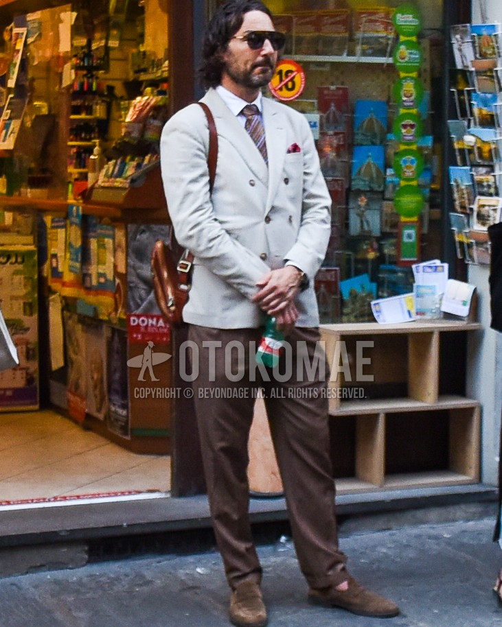 Men's spring summer autumn outfit with brown tortoiseshell sunglasses, gray plain tailored jacket, white plain shirt, brown plain slacks, brown coin loafers leather shoes, brown plain backpack, brown regimental necktie.