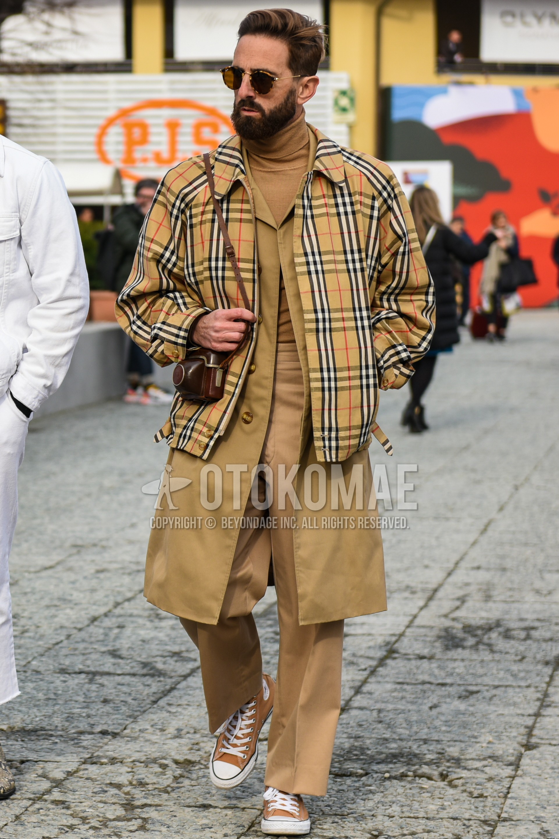 Men's autumn winter outfit with brown tortoiseshell sunglasses, beige check outerwear, beige plain stenkarrer coat, beige plain turtleneck knit, beige plain chinos, brown high-cut sneakers.