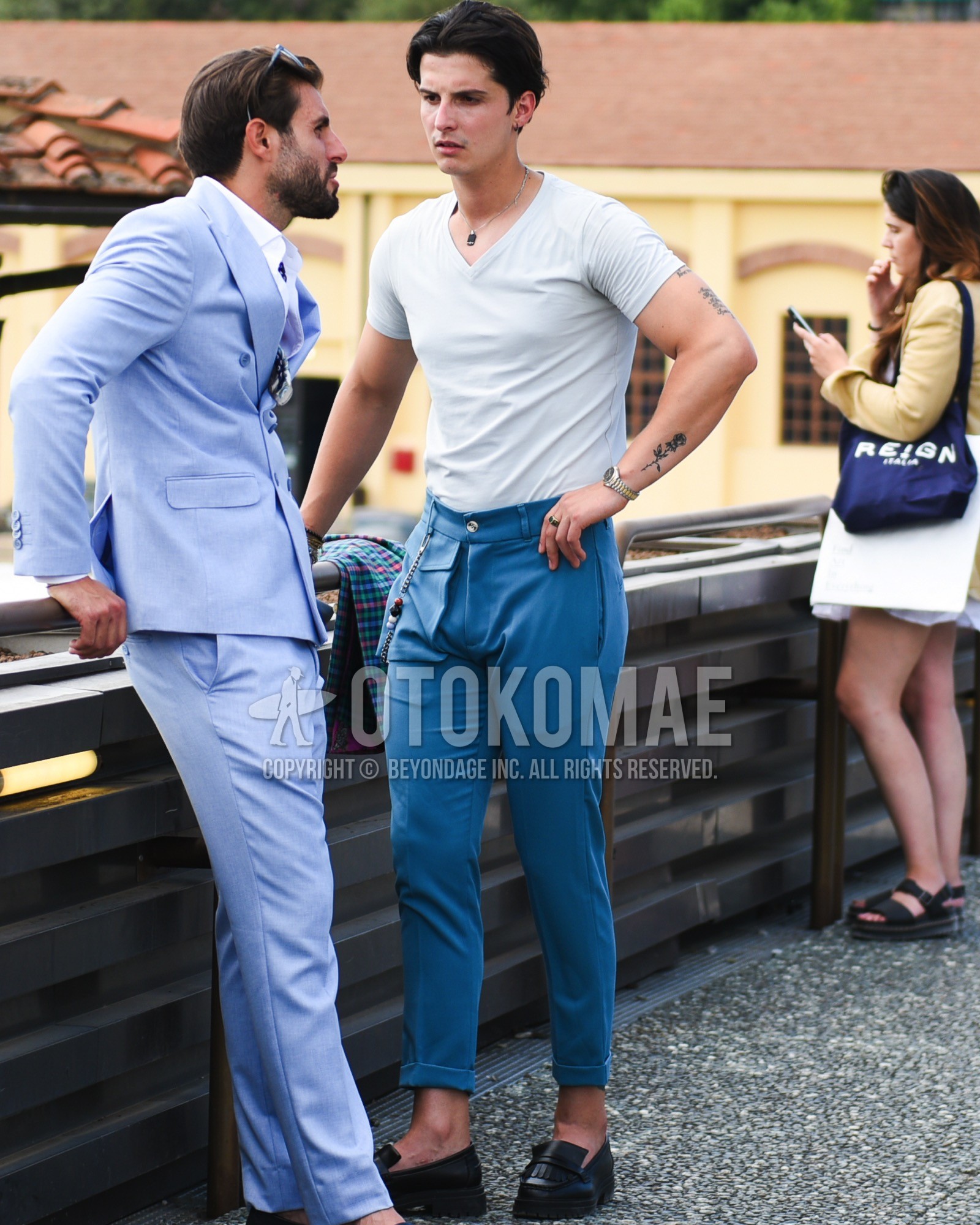 Men's spring summer outfit with white plain t-shirt, blue plain slacks, black coin loafers leather shoes.