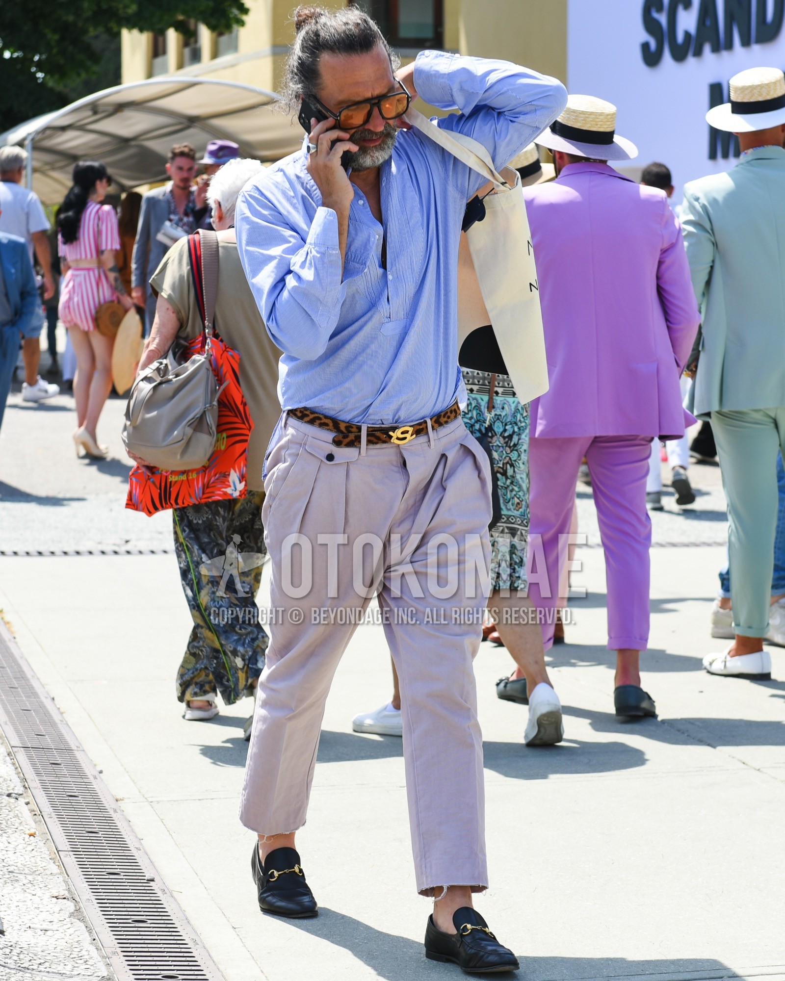 Men's spring summer outfit with plain sunglasses, blue plain shirt, brown leopard leather belt, purple plain slacks, black bit loafers leather shoes.