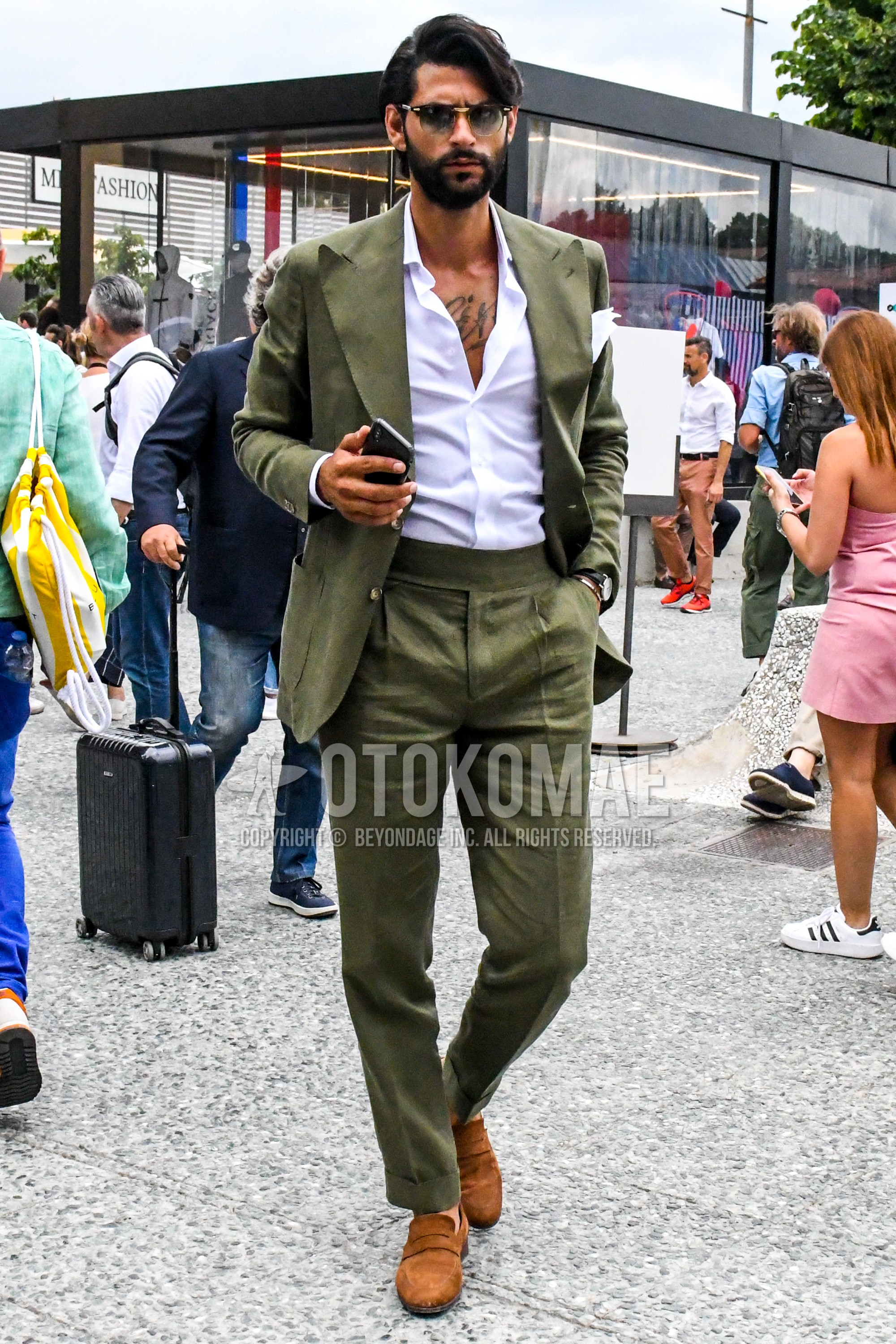 Men's spring summer autumn outfit with plain sunglasses, white plain shirt, brown coin loafers leather shoes, olive green plain suit.