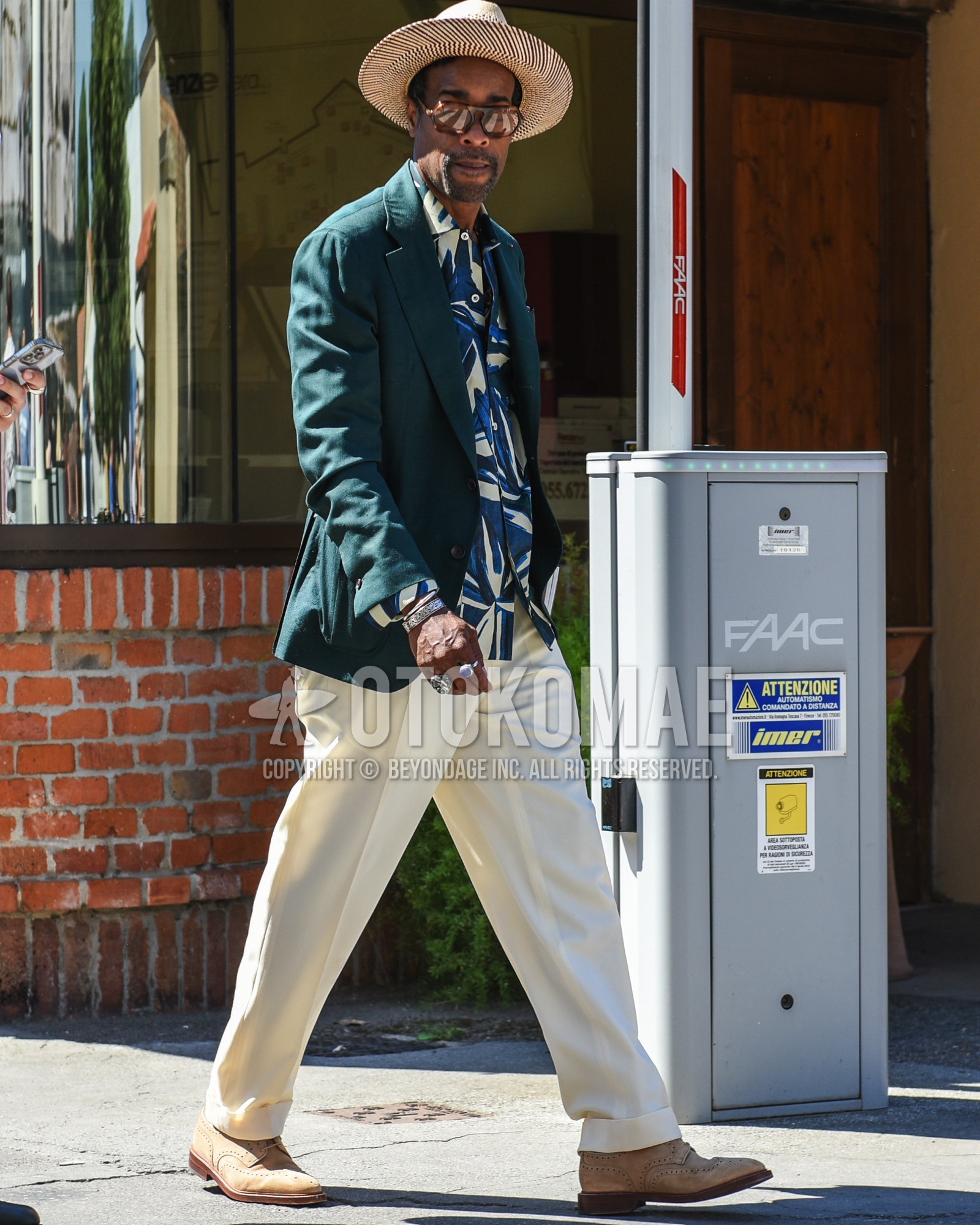 Men's spring summer outfit with beige plain hat, brown tortoiseshell sunglasses, green plain tailored jacket, tops/innerwear shirt, white plain slacks, beige brogue shoes leather shoes, beige suede shoes leather shoes.
